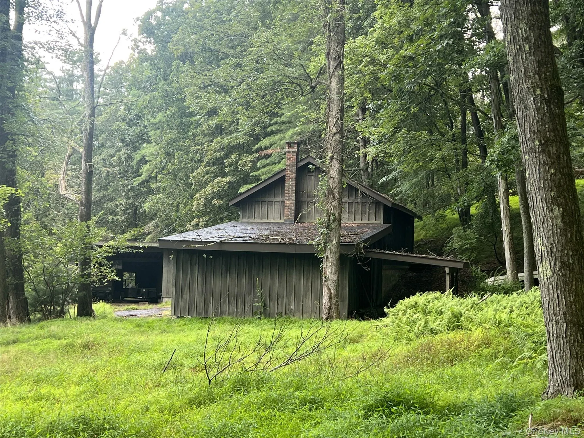 View of outbuilding featuring a wooded view View of outbuilding featuring a wooded view