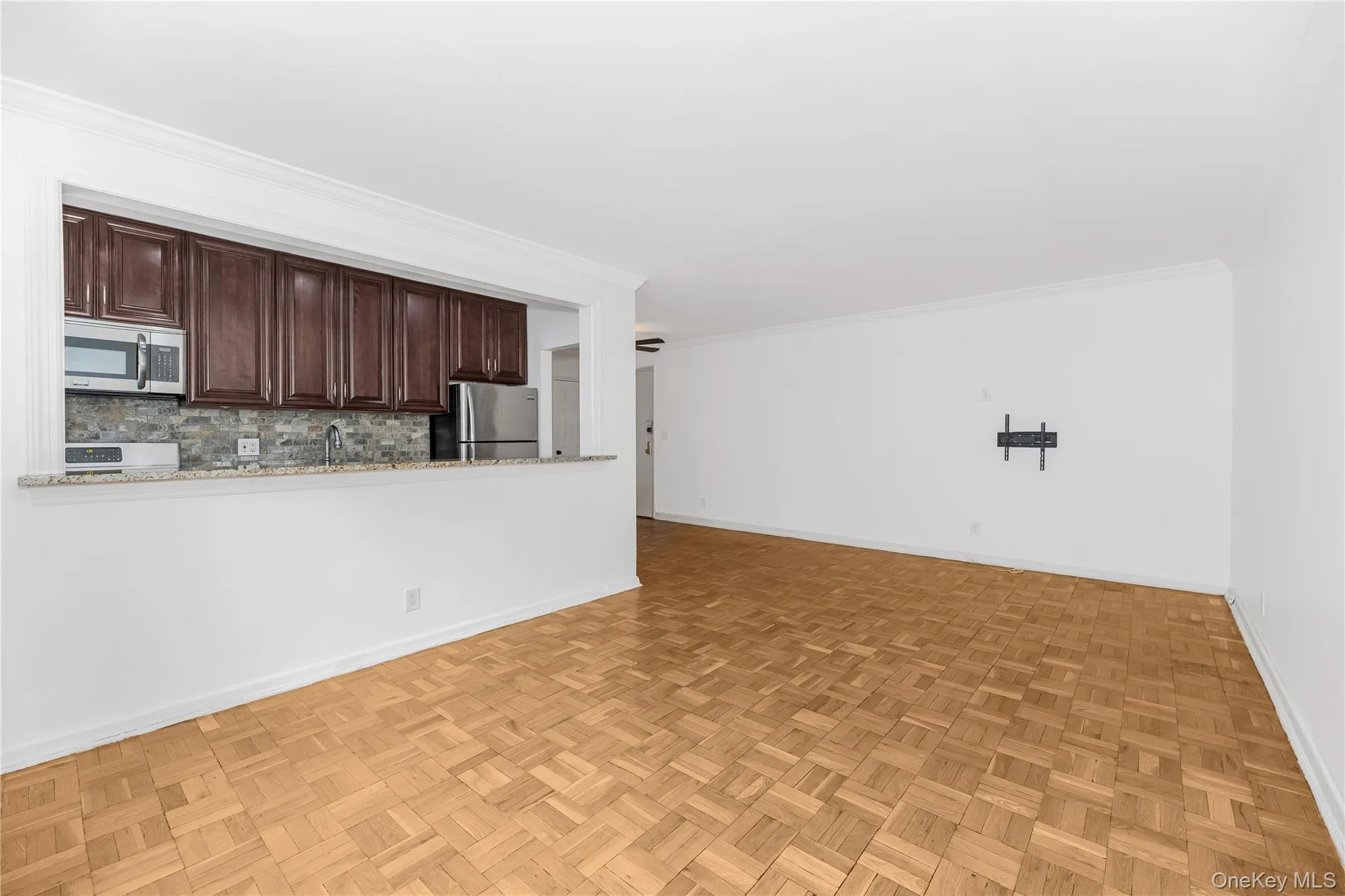 Unfurnished living room featuring crown molding Unfurnished living room featuring crown molding