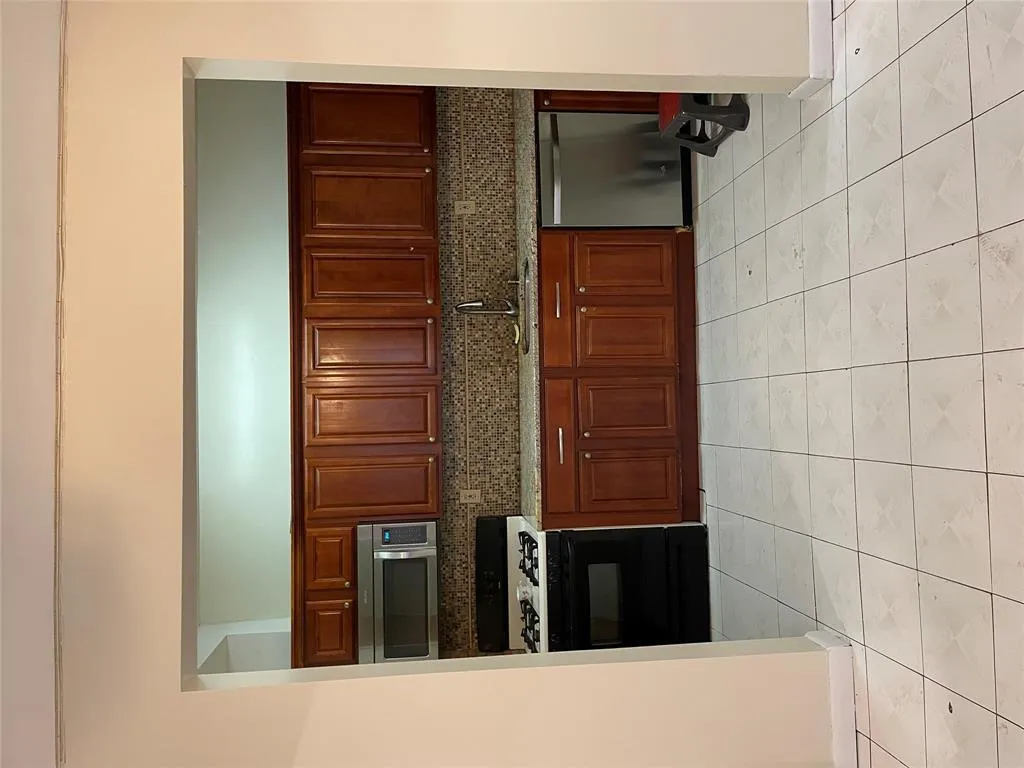 Kitchen featuring stove, decorative backsplash, dishwashing machine, and light tile patterned flooring Kitchen featuring stove, decorative backsplash, dishwashing machine, and light tile patterned flooring