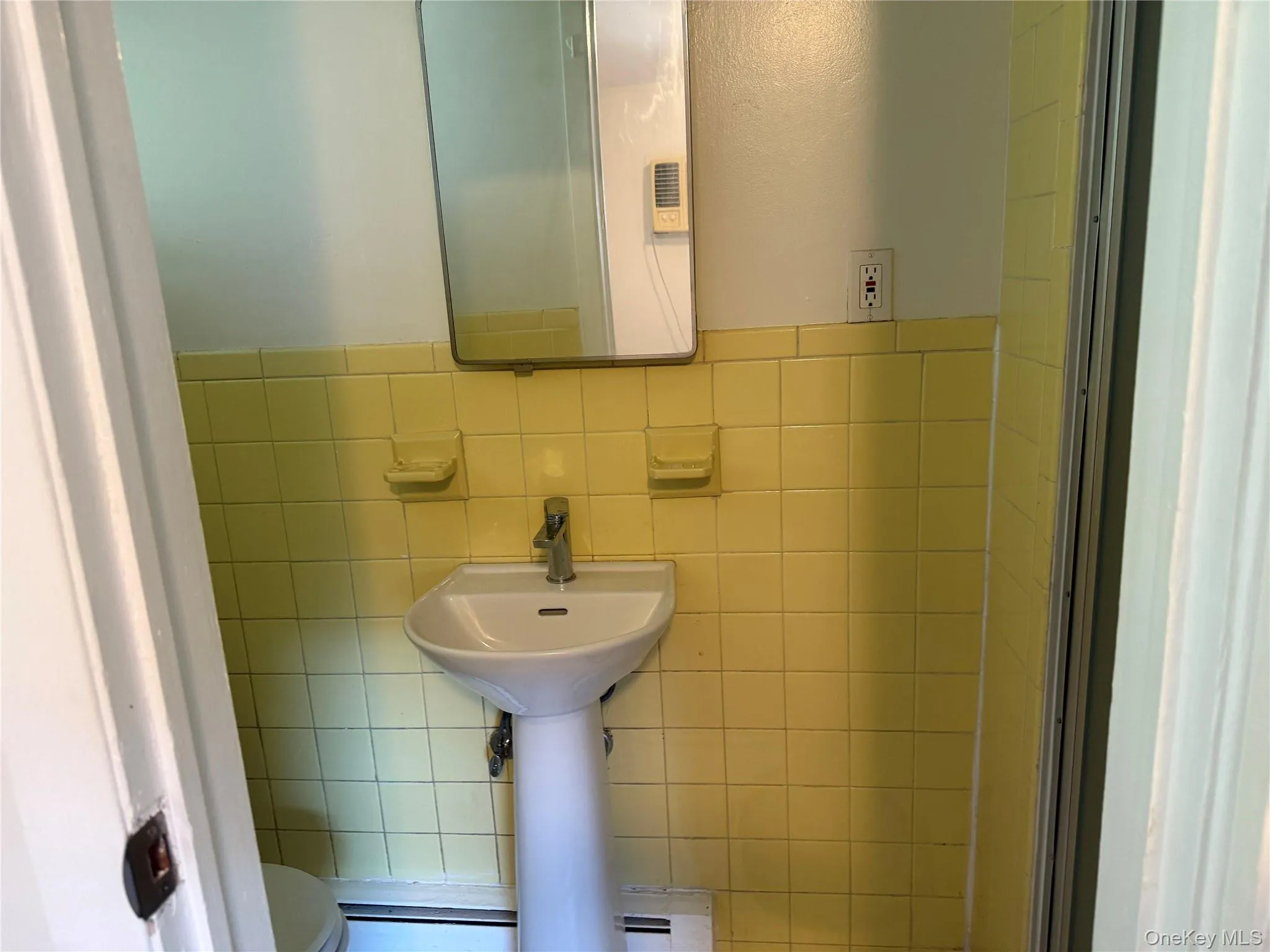 Master Bathroom with tile walls, a baseboard radiator, and shower stall. Master Bathroom with tile walls, a baseboard radiator, and shower stall.