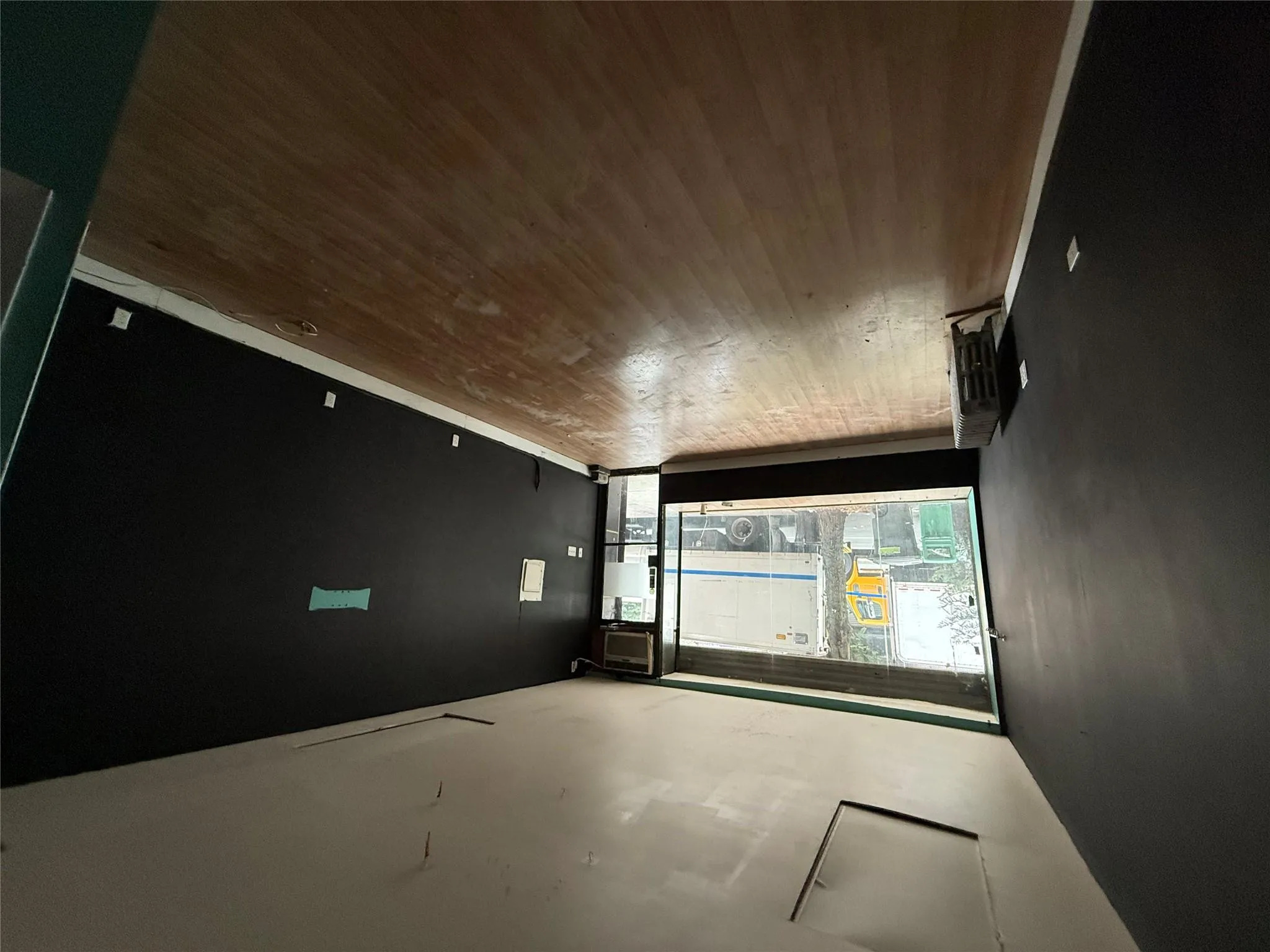 Empty room with wood finished floors and attic access Empty room with wood finished floors and attic access