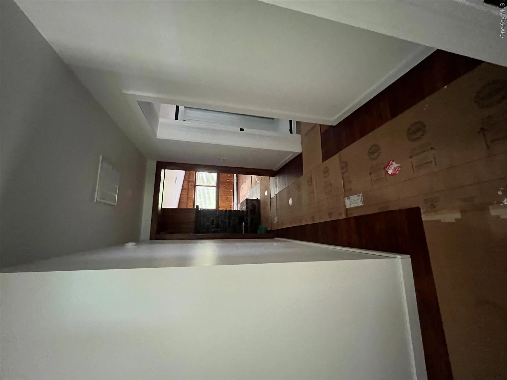 Corridor featuring wood finished floors Corridor featuring wood finished floors