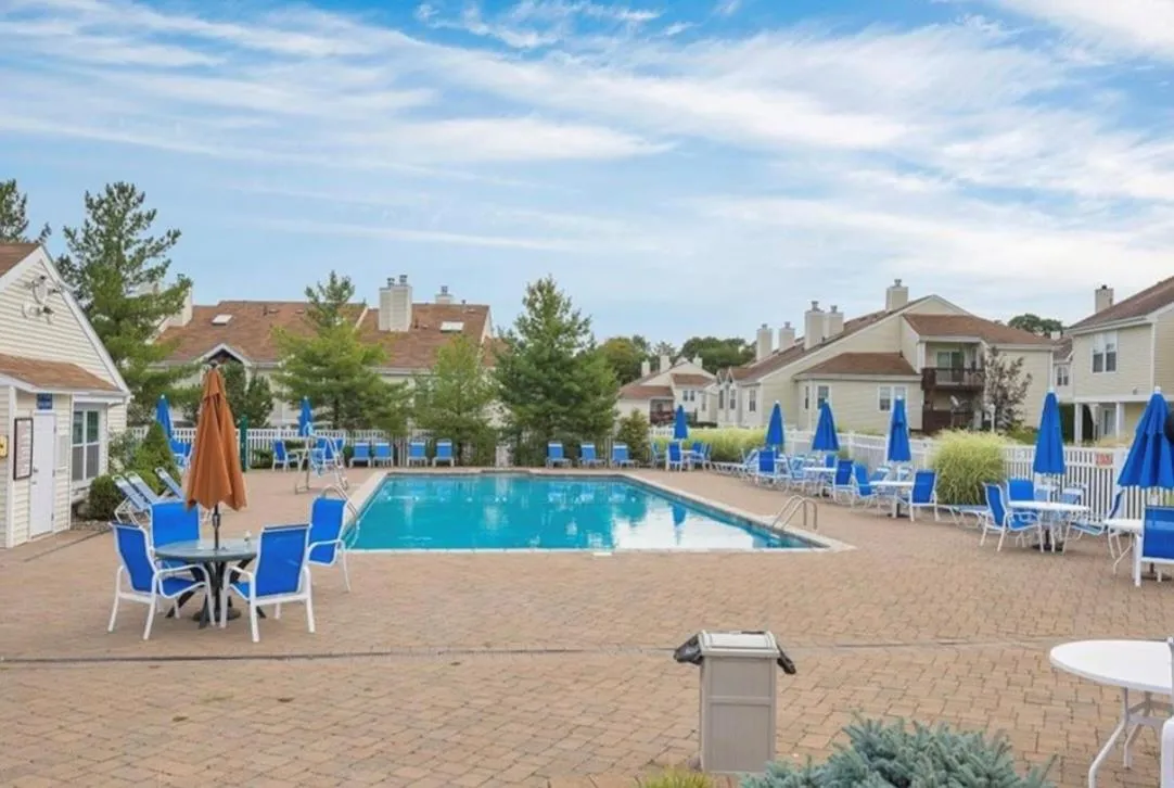 Community pool with a patio area and a residential view Community pool with a patio area and a residential view