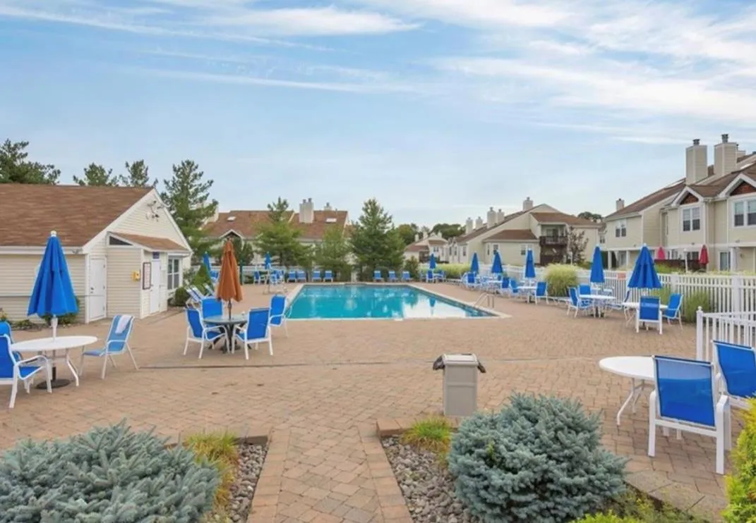 Community pool with a patio and a residential view Community pool with a patio and a residential view