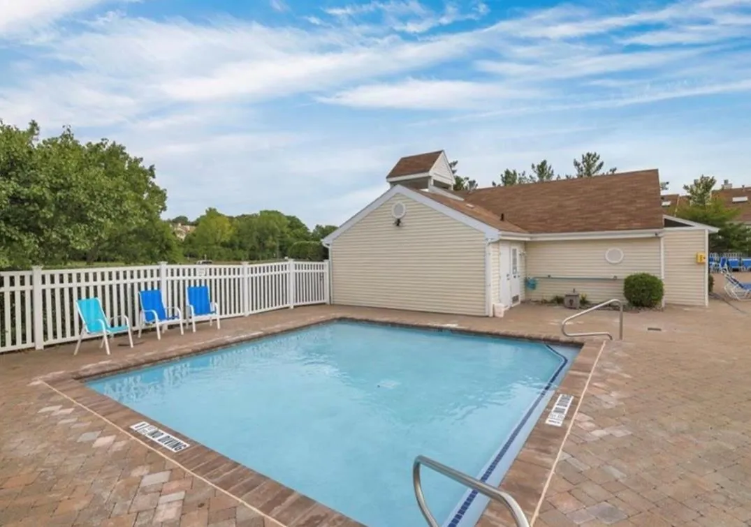 Community pool featuring a patio area Community pool featuring a patio area