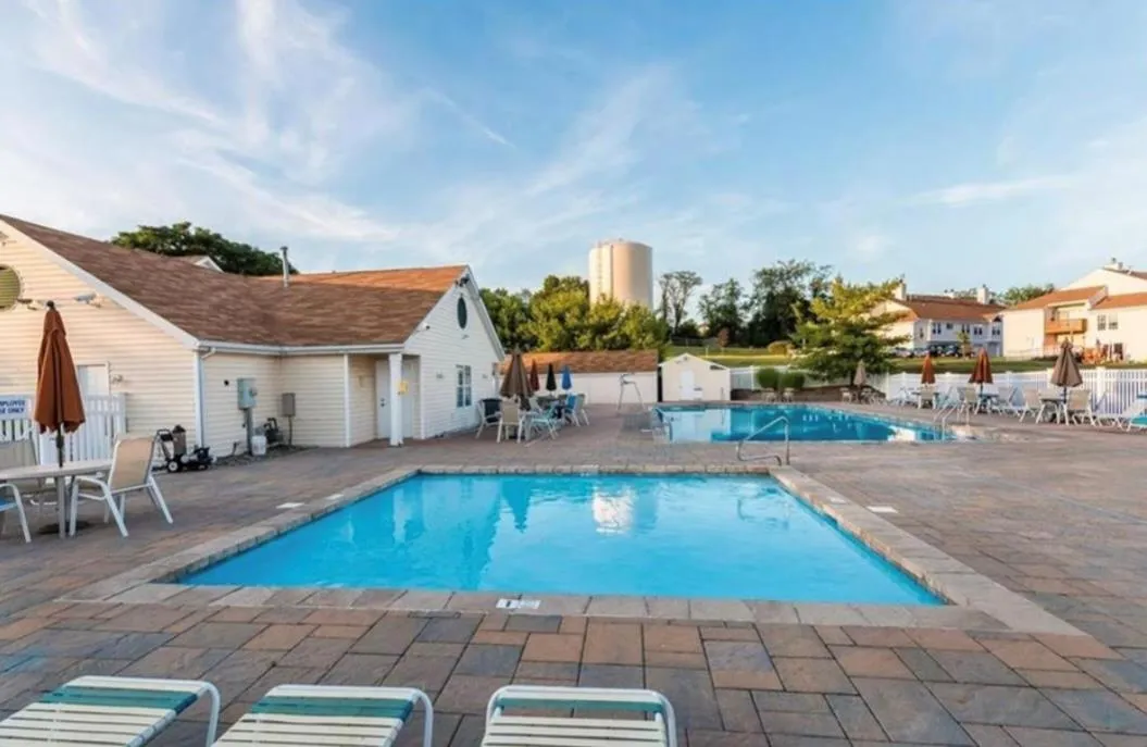 Community pool with a patio area Community pool with a patio area