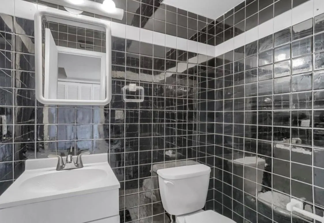 Bathroom featuring tile walls and vanity Bathroom featuring tile walls and vanity