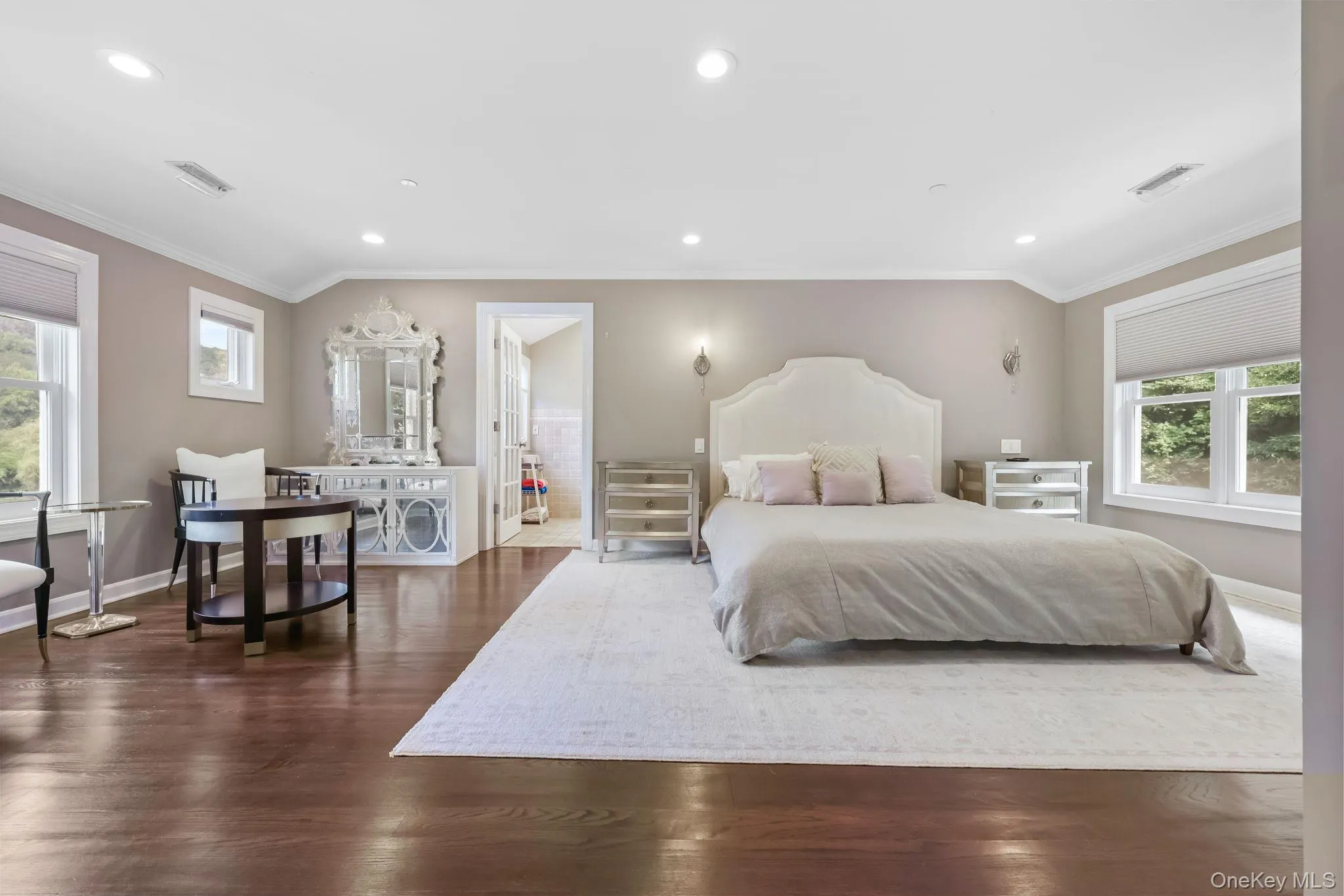 Bedroom with crown molding, recessed lighting, and dark wood finished floors Bedroom with crown molding, recessed lighting, and dark wood finished floors