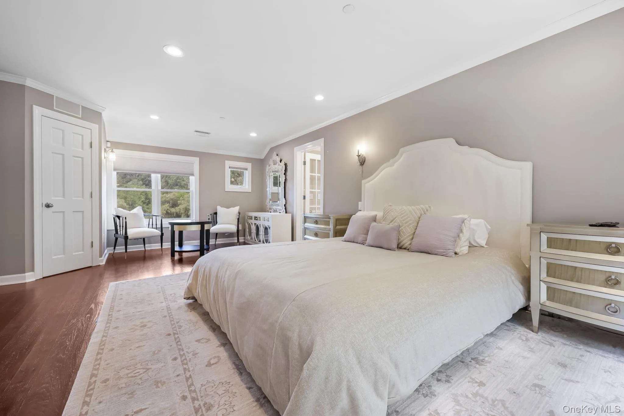 Bedroom with crown molding, recessed lighting, and wood finished floors Bedroom with crown molding, recessed lighting, and wood finished floors