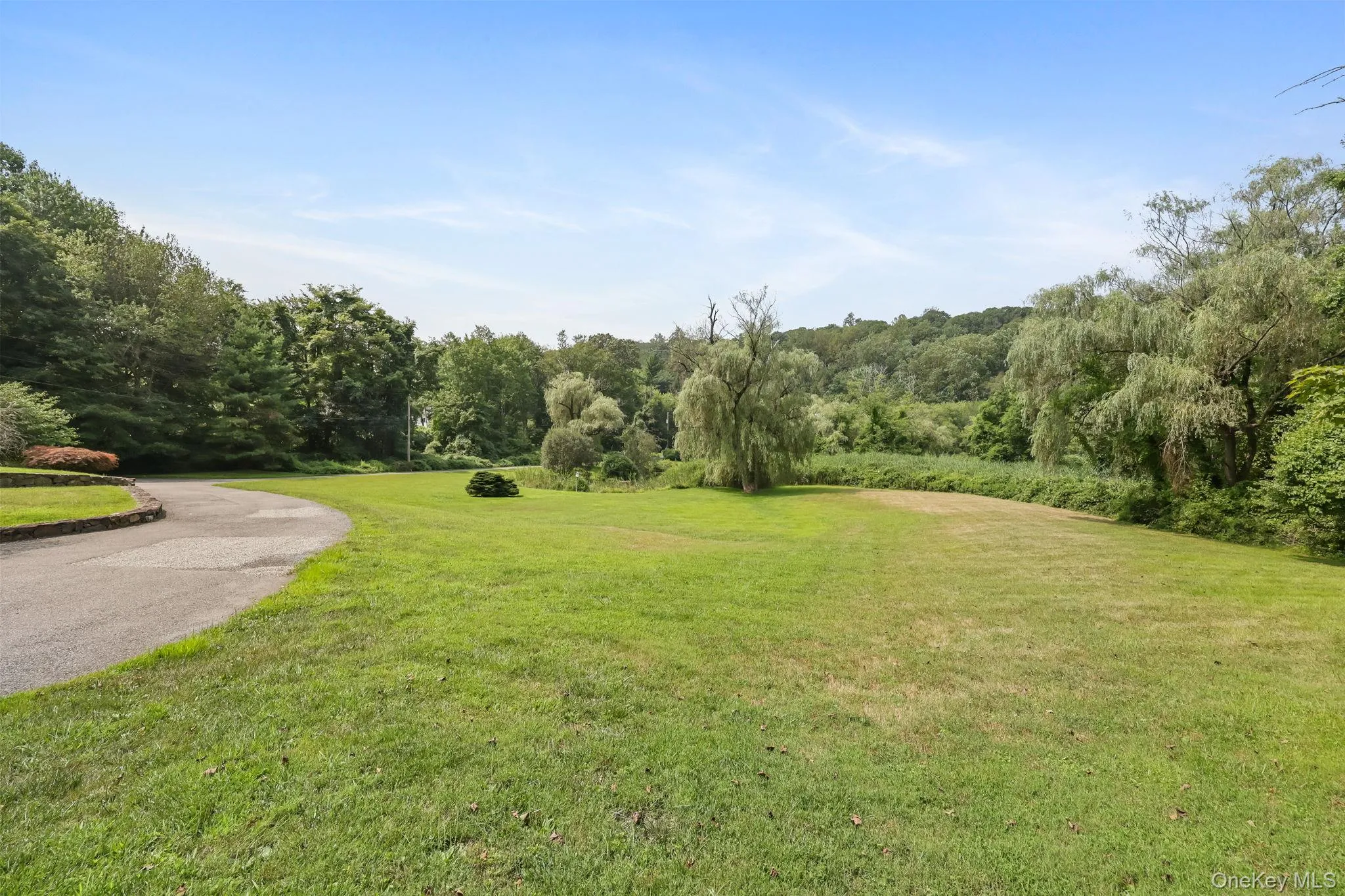 View of property's community featuring a lawn View of property's community featuring a lawn