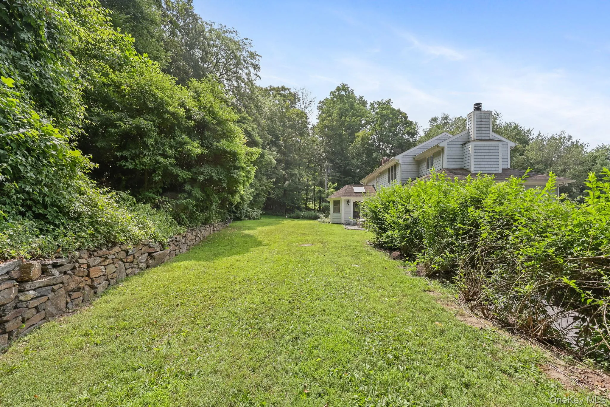 View of green lawn featuring view of scattered trees View of green lawn featuring view of scattered trees