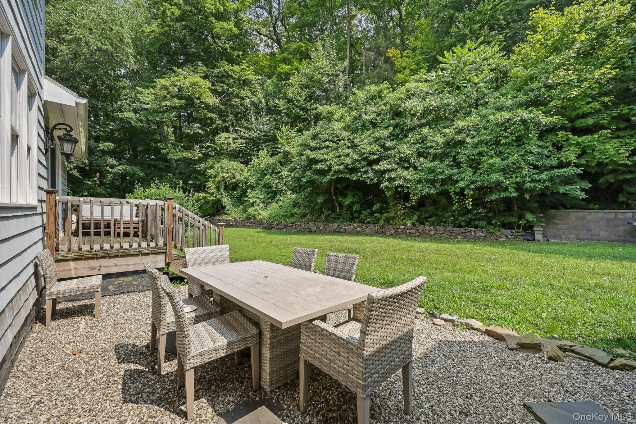 View of patio featuring outdoor dining space and view of scattered trees View of patio featuring outdoor dining space and view of scattered trees