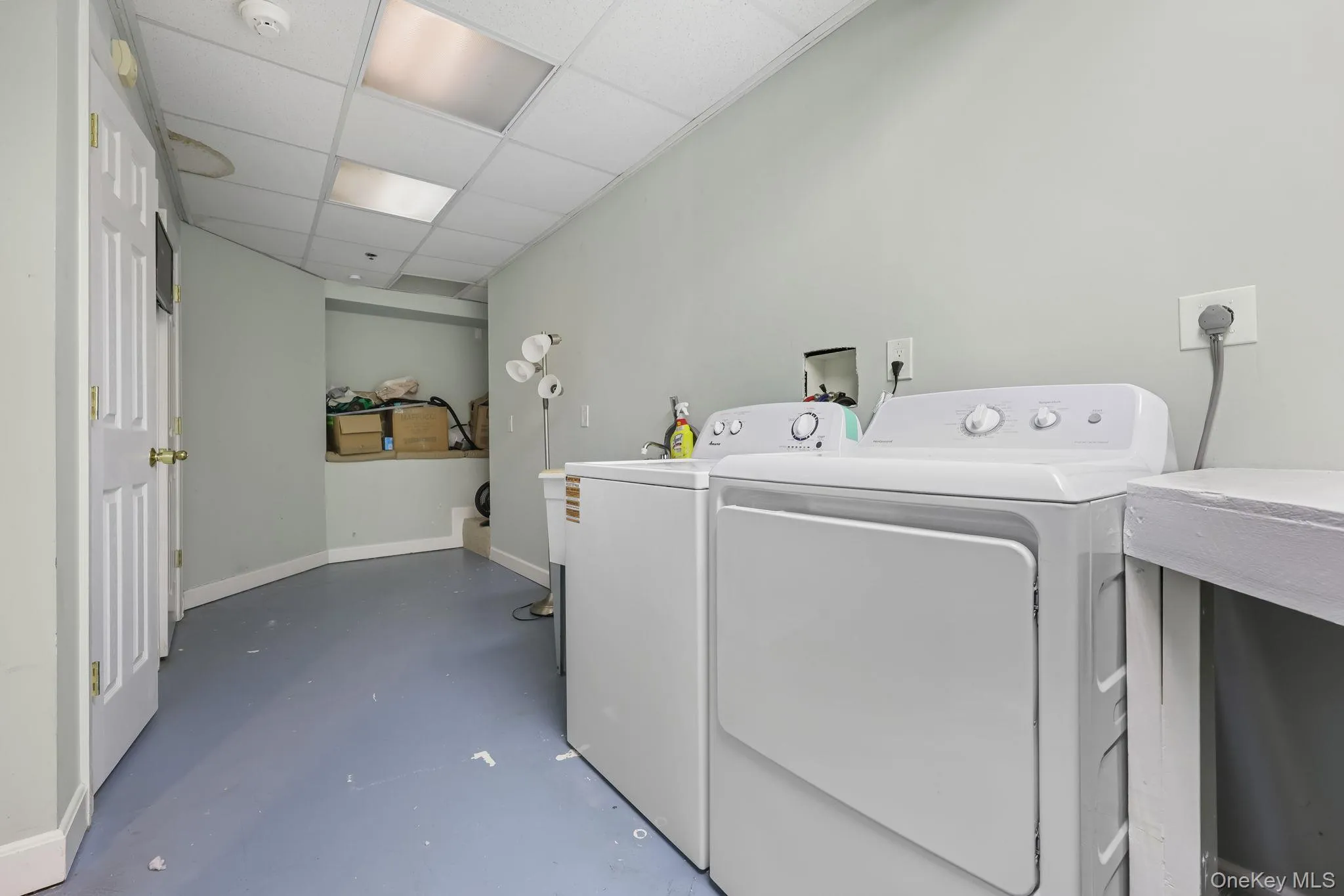 Washroom with baseboards and washing machine and clothes dryer Washroom with baseboards and washing machine and clothes dryer