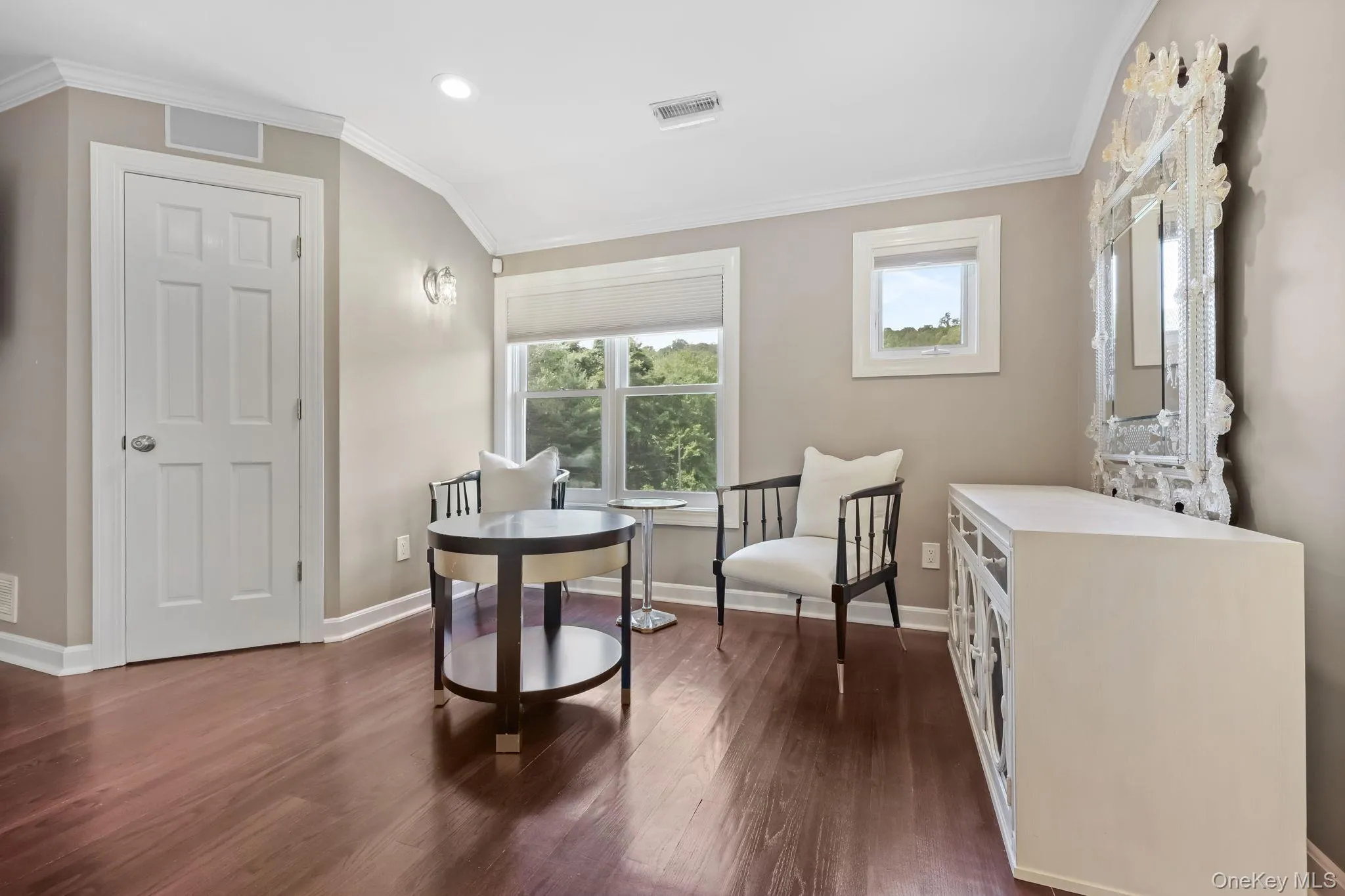 Sitting room with crown molding, dark wood-type flooring, recessed lighting, and vaulted ceiling Sitting room with crown molding, dark wood-type flooring, recessed lighting, and vaulted ceiling