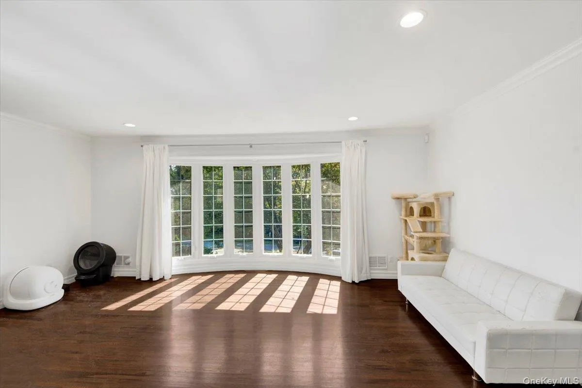 Unfurnished room featuring ornamental molding, recessed lighting, and dark wood-type flooring Unfurnished room featuring ornamental molding, recessed lighting, and dark wood-type flooring