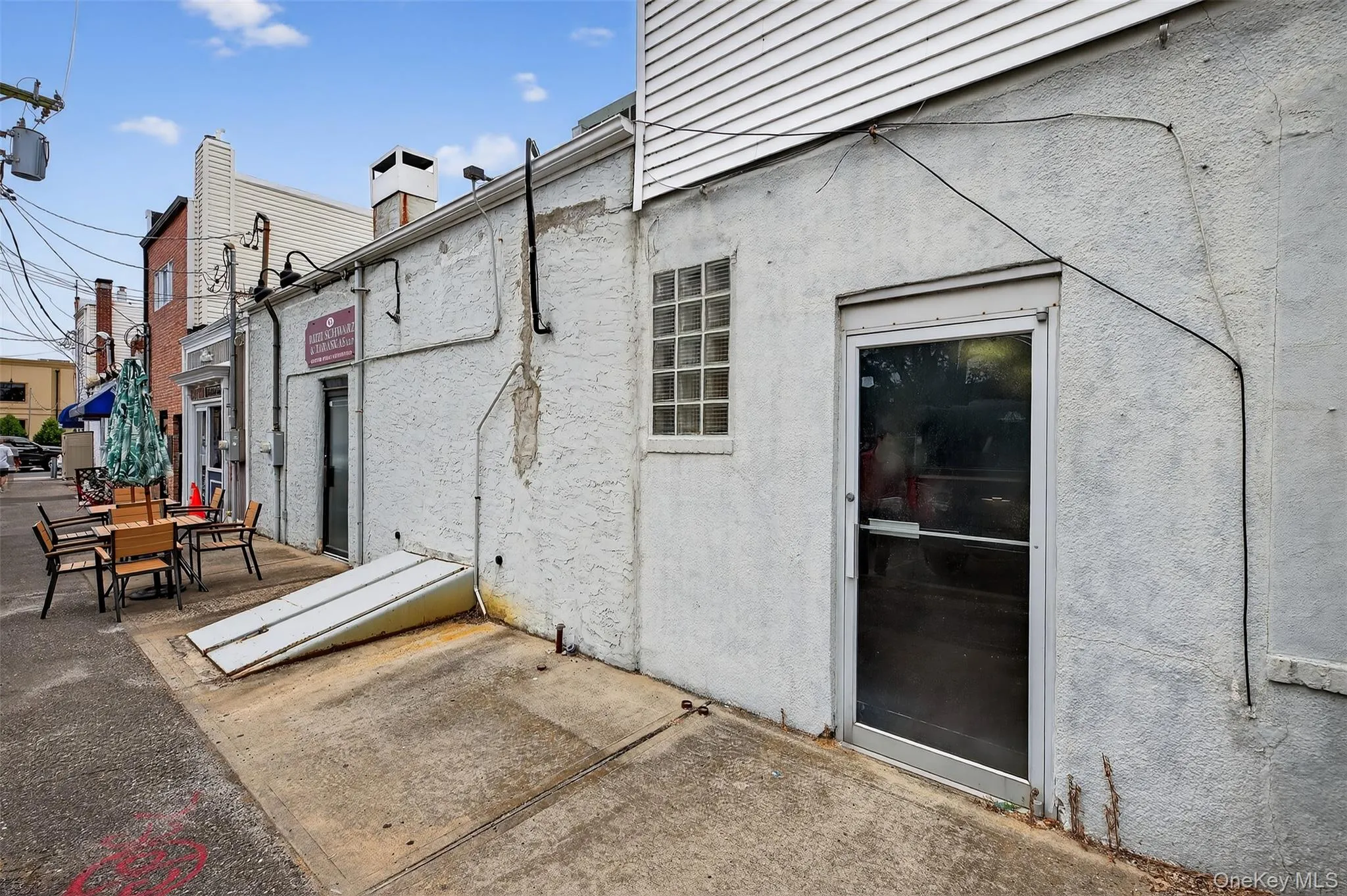 Rear view of property with a patio area and stucco siding Rear view of property with a patio area and stucco siding