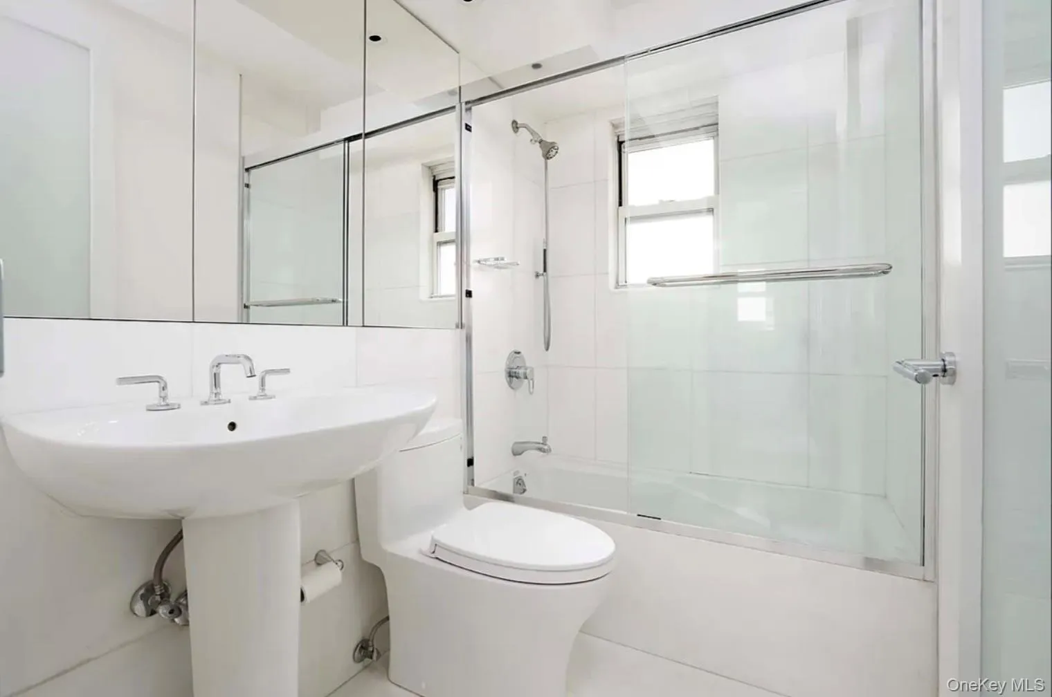 Full bath featuring combined bath / shower with glass door and toilet Full bath featuring combined bath / shower with glass door and toilet