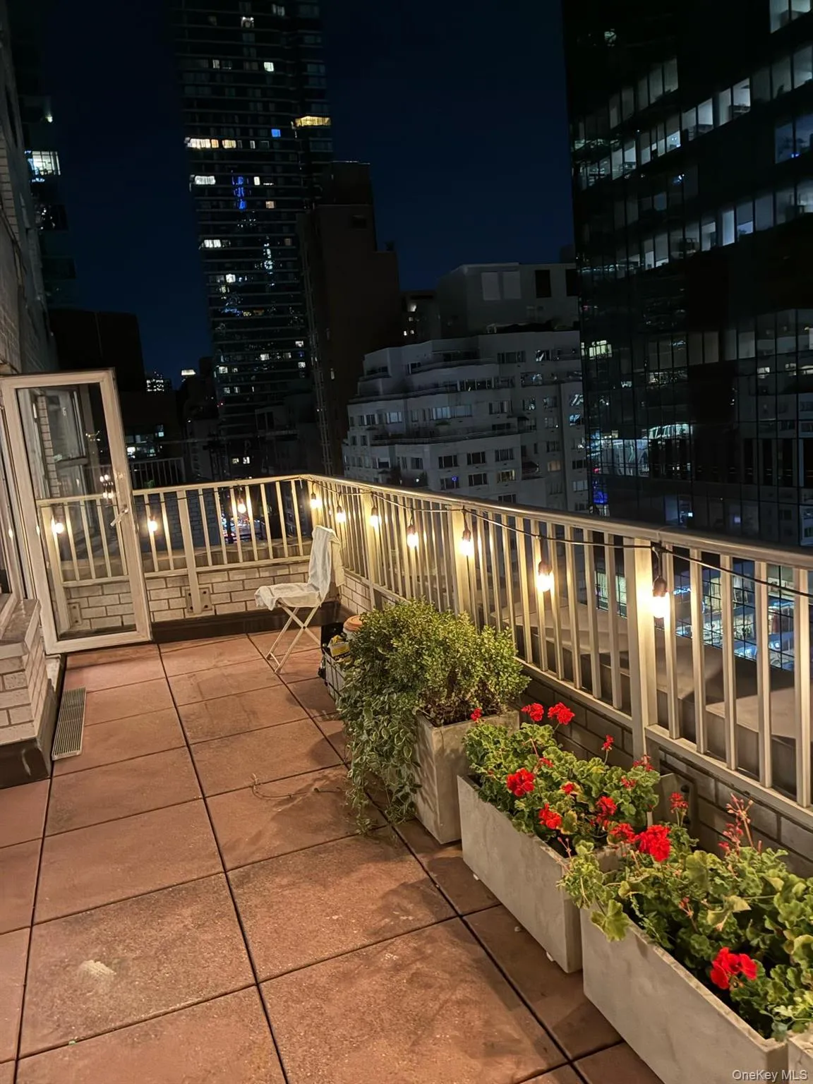 Balcony featuring a view of city lights Balcony featuring a view of city lights