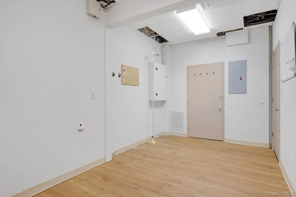 Hall with electric panel and light wood-style floors Hall with electric panel and light wood-style floors