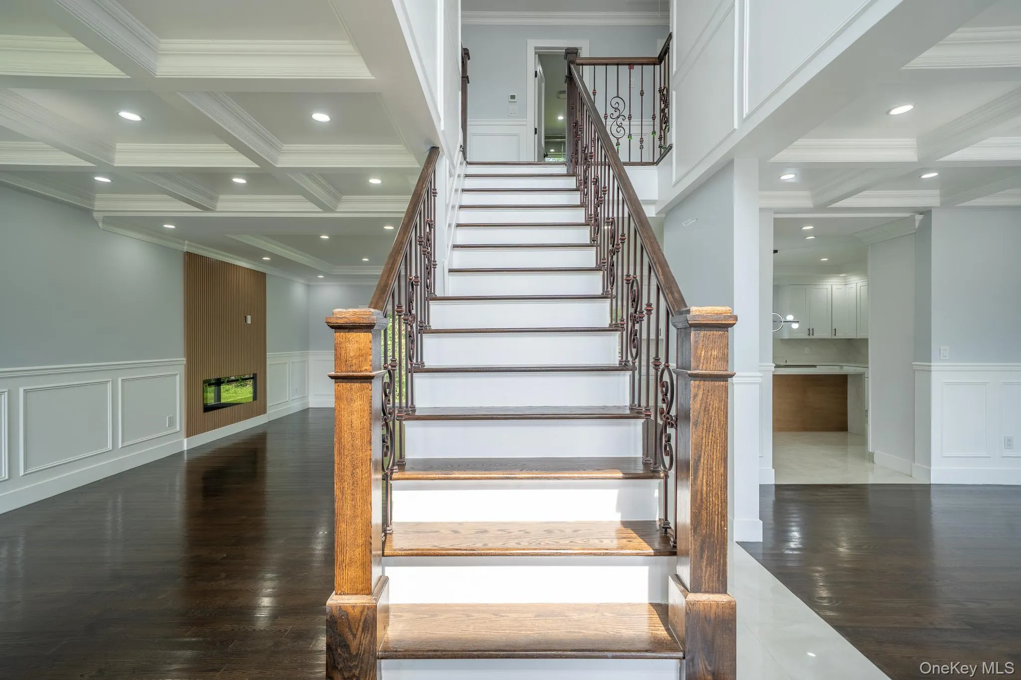 Stairway with a decorative wall, wainscoting, coffered ceiling, beam ceiling, and crown molding Stairway with a decorative wall, wainscoting, coffered ceiling, beam ceiling, and crown molding
