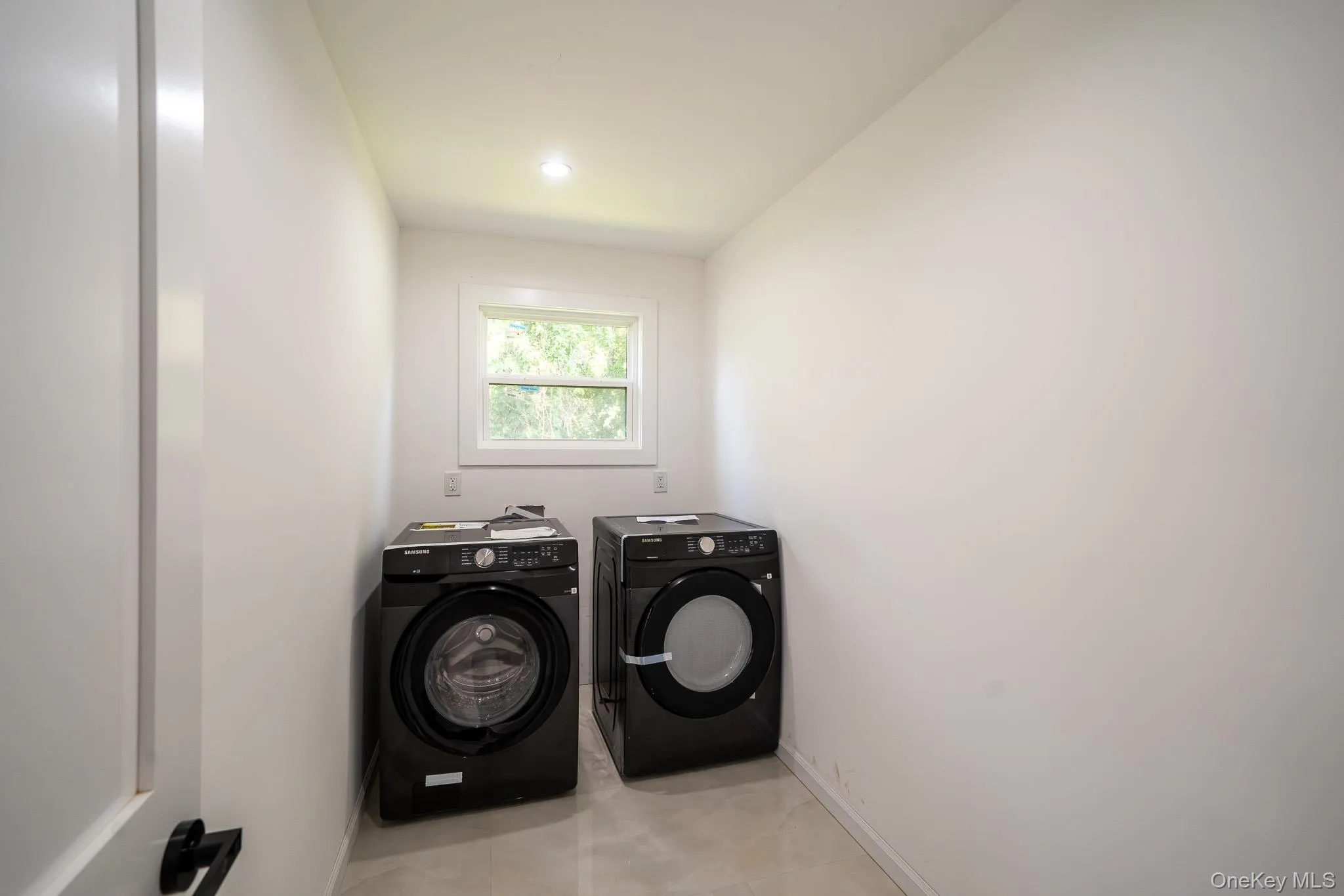 Laundry room featuring separate washer and dryer and recessed lighting Laundry room featuring separate washer and dryer and recessed lighting