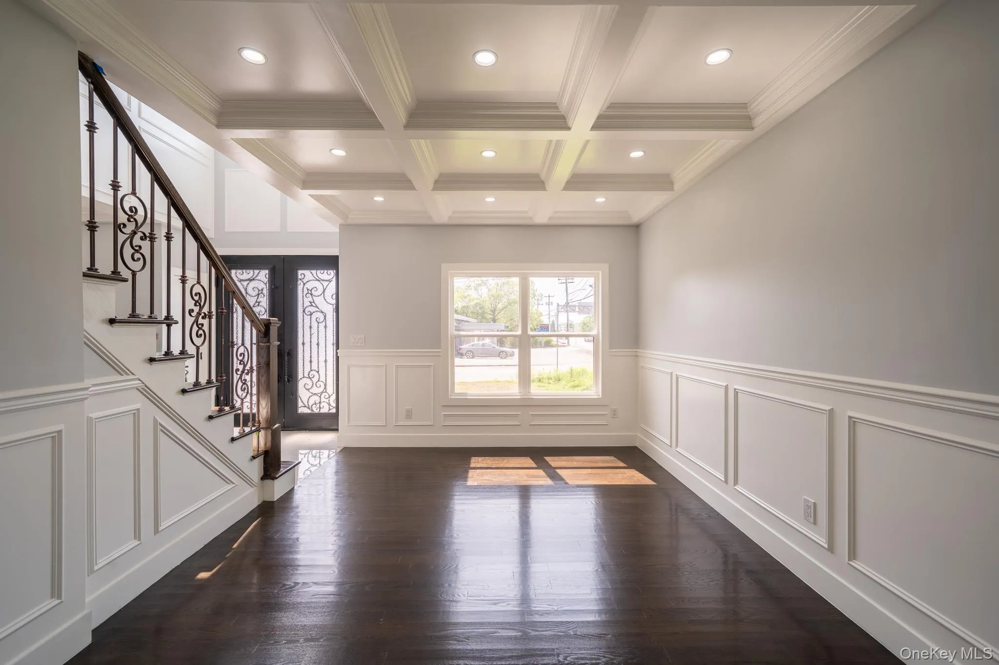 Entrance foyer featuring crown molding, beam ceiling, stairs, coffered ceiling, and dark wood-style flooring Entrance foyer featuring crown molding, beam ceiling, stairs, coffered ceiling, and dark wood-style flooring