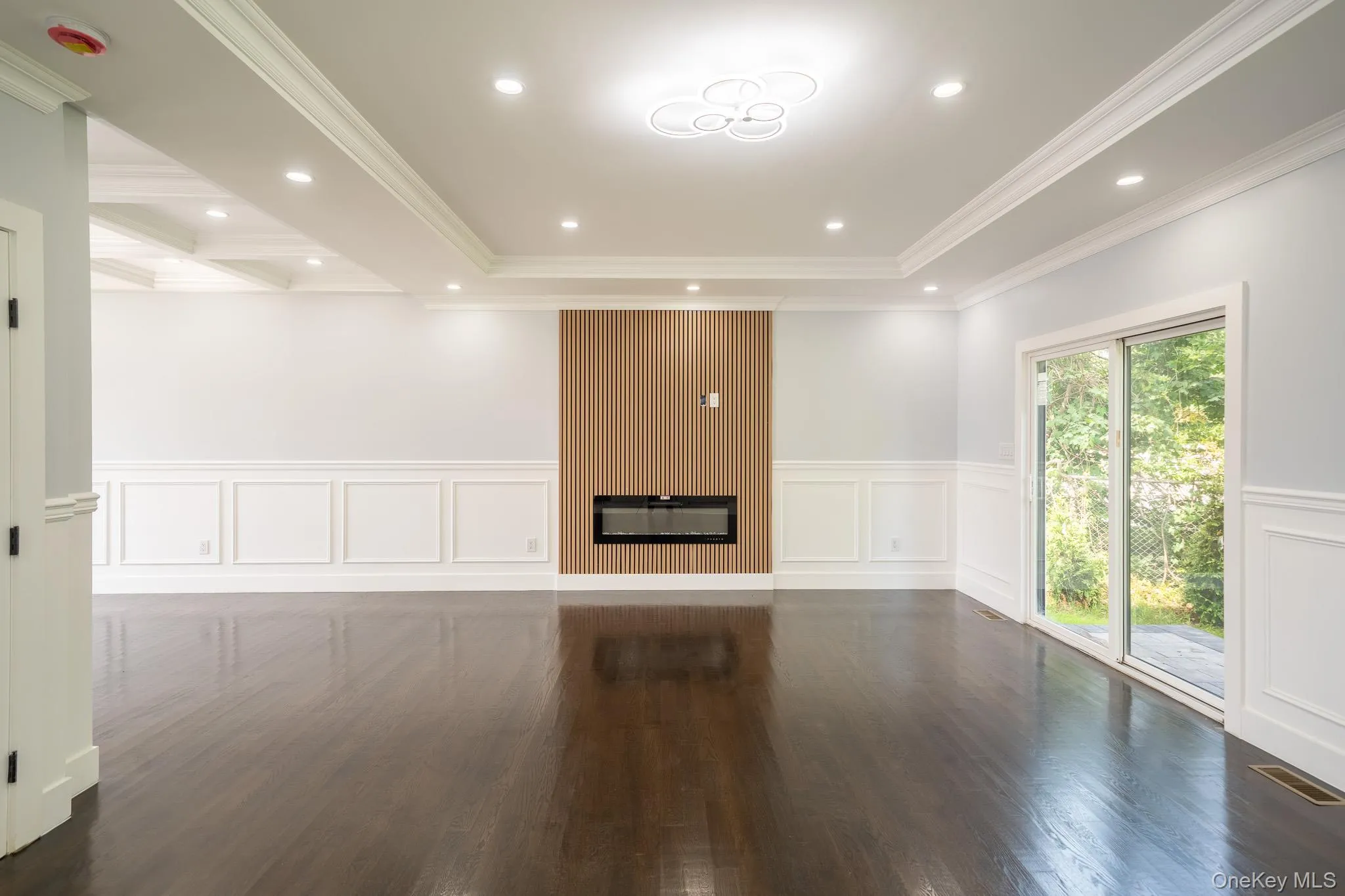Unfurnished room featuring a decorative wall, a wainscoted wall, wood finished floors, crown molding, and recessed lighting Unfurnished room featuring a decorative wall, a wainscoted wall, wood finished floors, crown molding, and recessed lighting