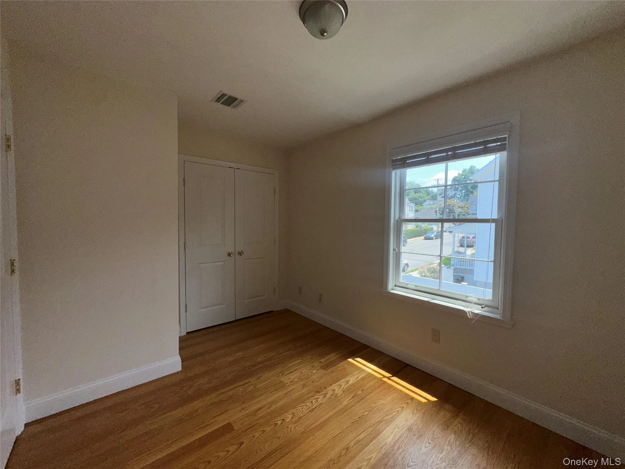 Unfurnished bedroom with light wood-style floors and a closet Unfurnished bedroom with light wood-style floors and a closet