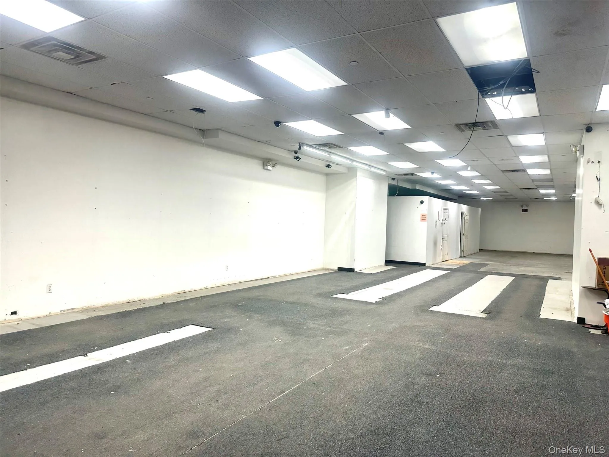 Unfurnished room featuring a drop ceiling Unfurnished room featuring a drop ceiling