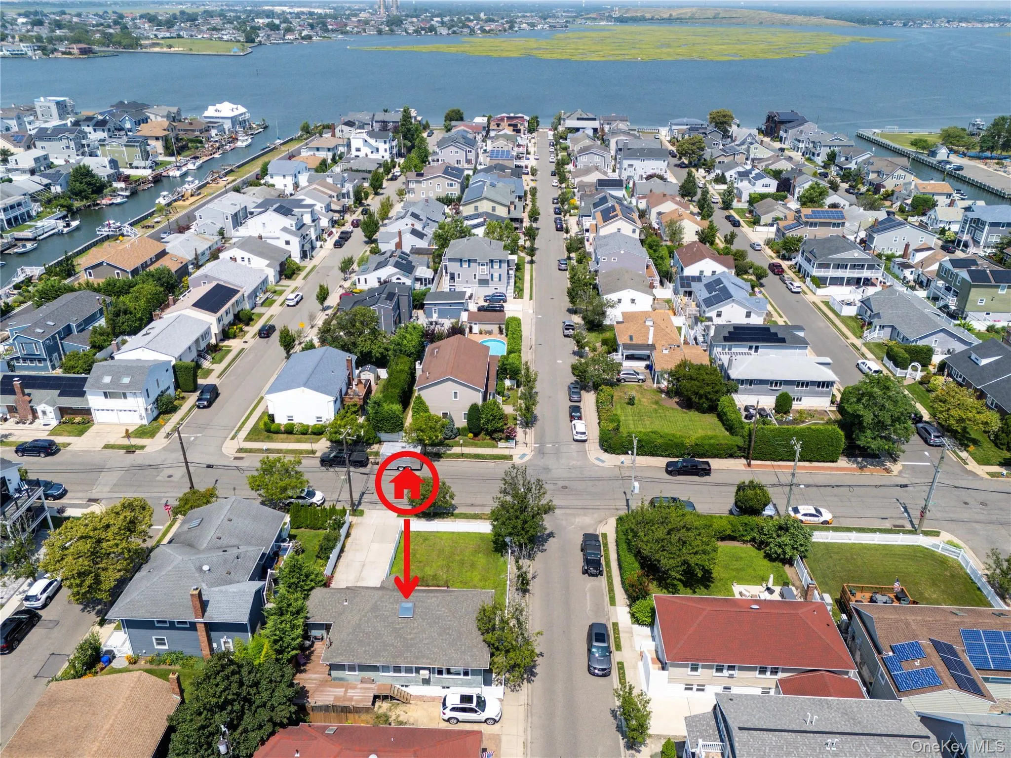 Aerial perspective of suburban area with a nearby body of water Aerial perspective of suburban area with a nearby body of water