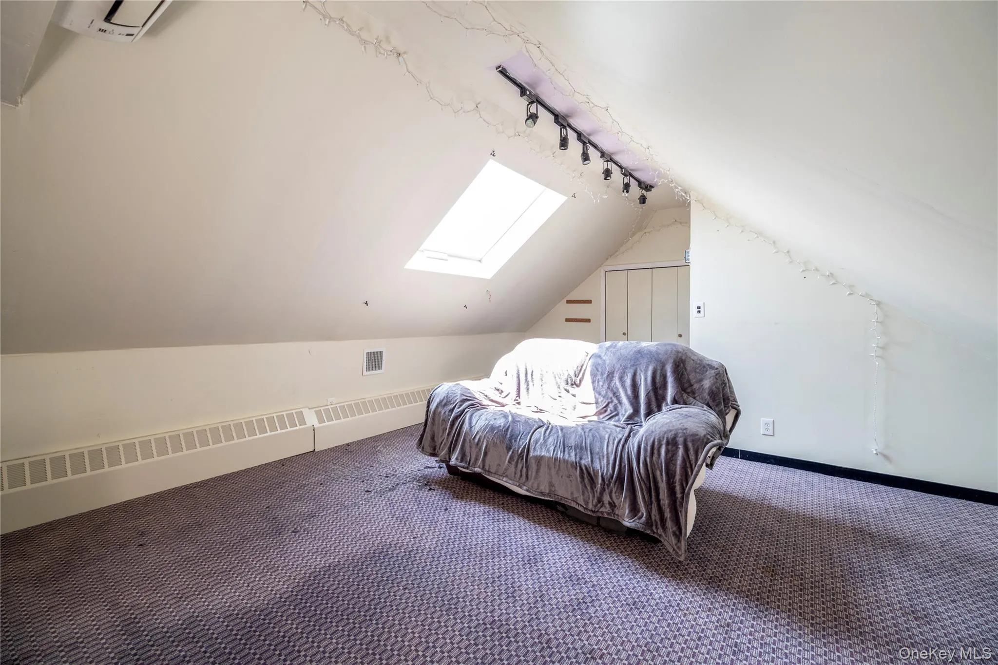 Additional living space with vaulted ceiling, carpet floors, and a skylight Additional living space with vaulted ceiling, carpet floors, and a skylight