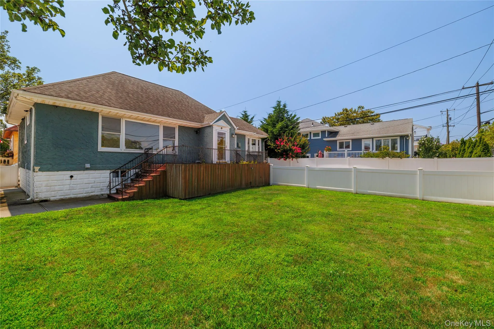 Back of house featuring a shingled roof and a residential view Back of house featuring a shingled roof and a residential view