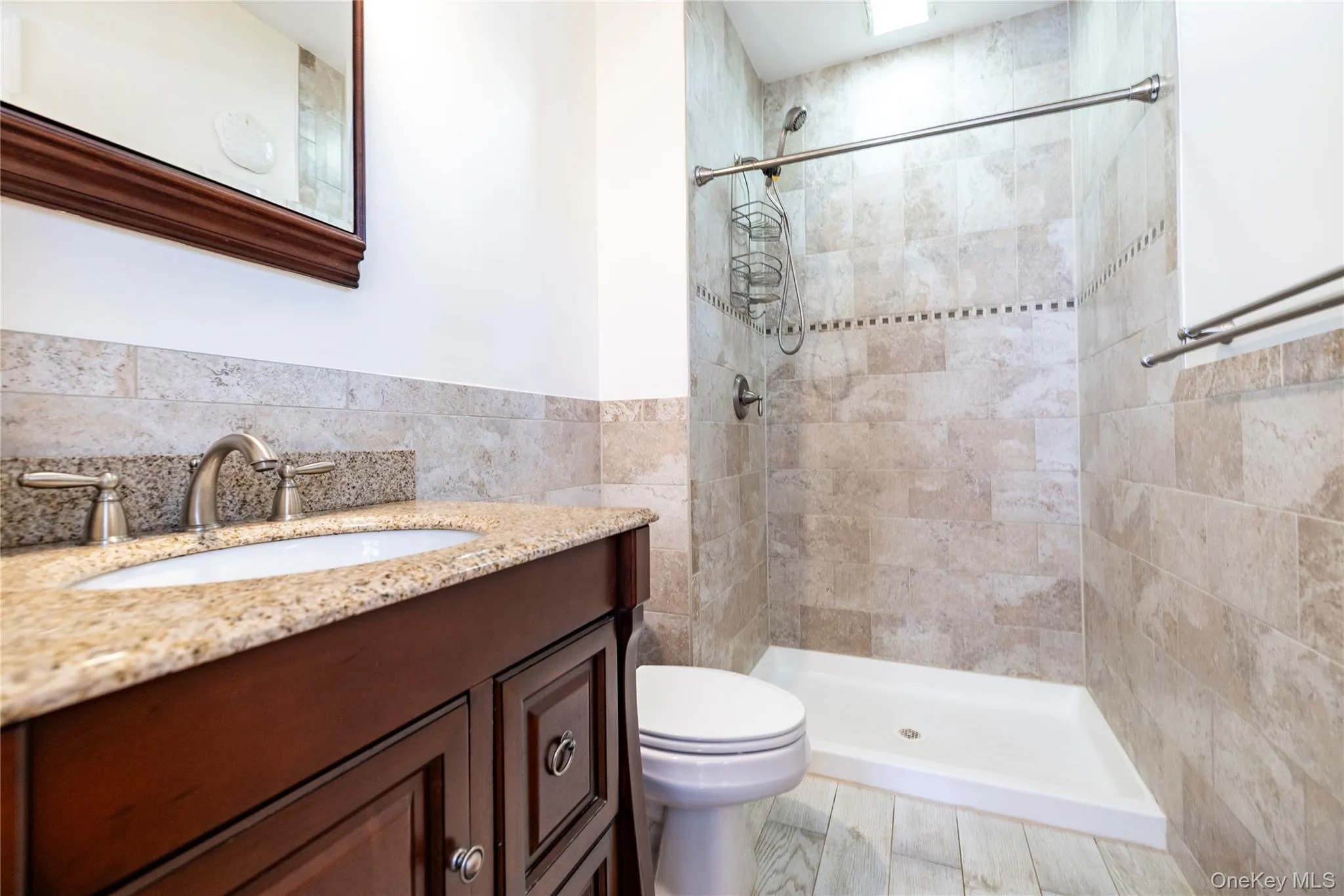 PRIMARY Full bath with vanity, tiled shower, and tile walls PRIMARY Full bath with vanity, tiled shower, and tile walls