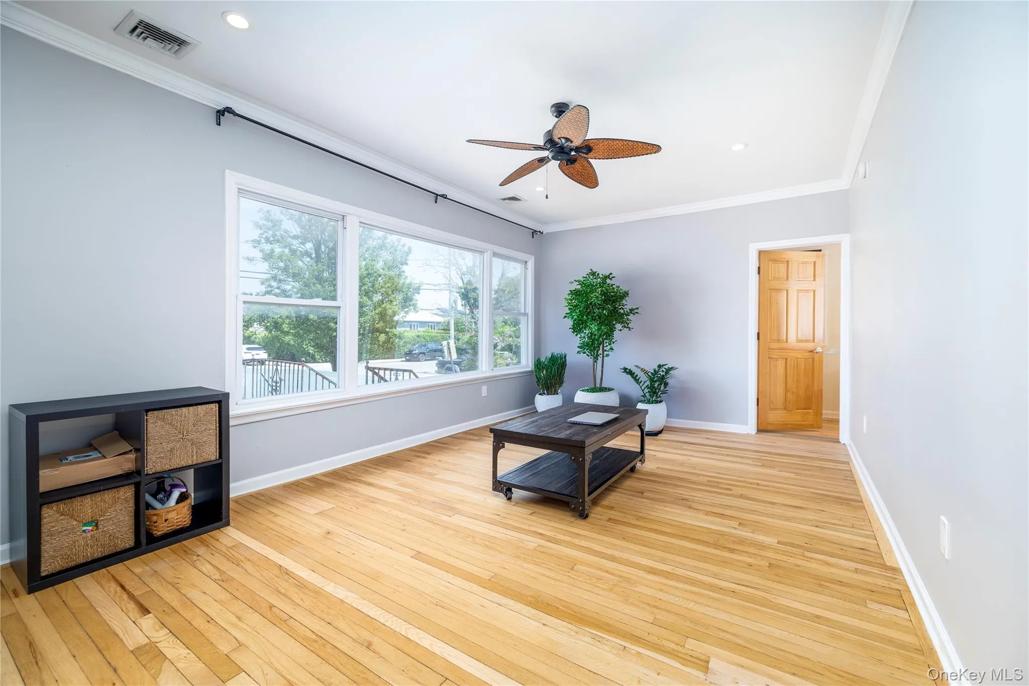 Sitting room with crown molding, light wood-type flooring, a ceiling fan, and recessed lighting Sitting room with crown molding, light wood-type flooring, a ceiling fan, and recessed lighting