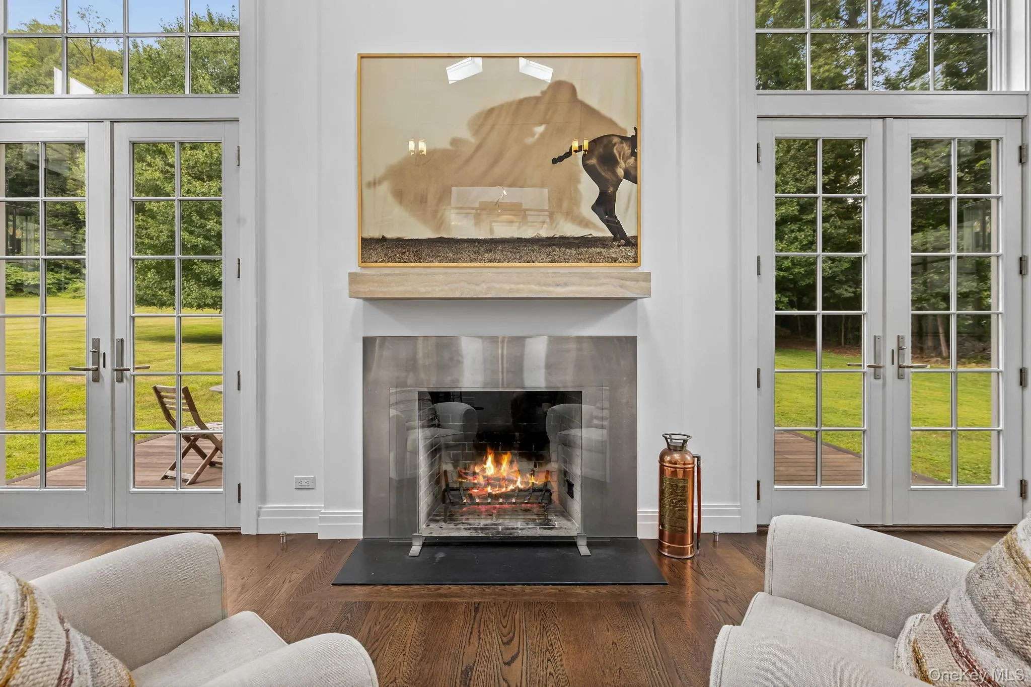 Great room with wood burning fireplace and double french doors to deck Great room with wood burning fireplace and double french doors to deck