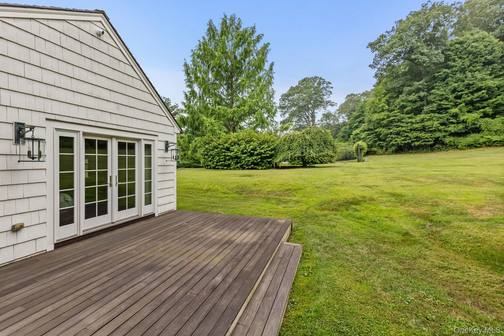 Deck with french doors to primary suite Deck with french doors to primary suite