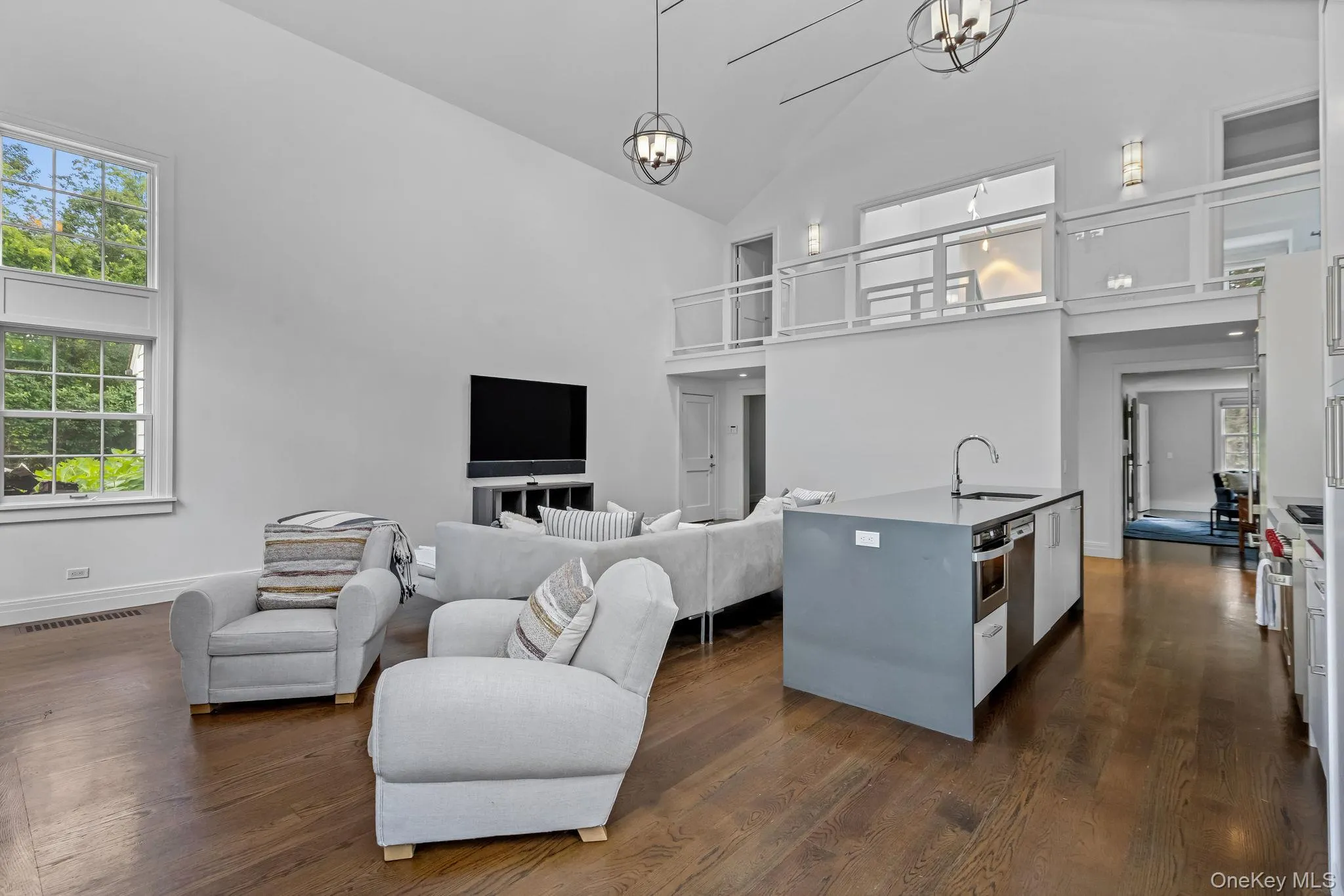 Great room with open kitchen, wood burning fireplace, vaulted ceiling and wood floors Great room with open kitchen, wood burning fireplace, vaulted ceiling and wood floors