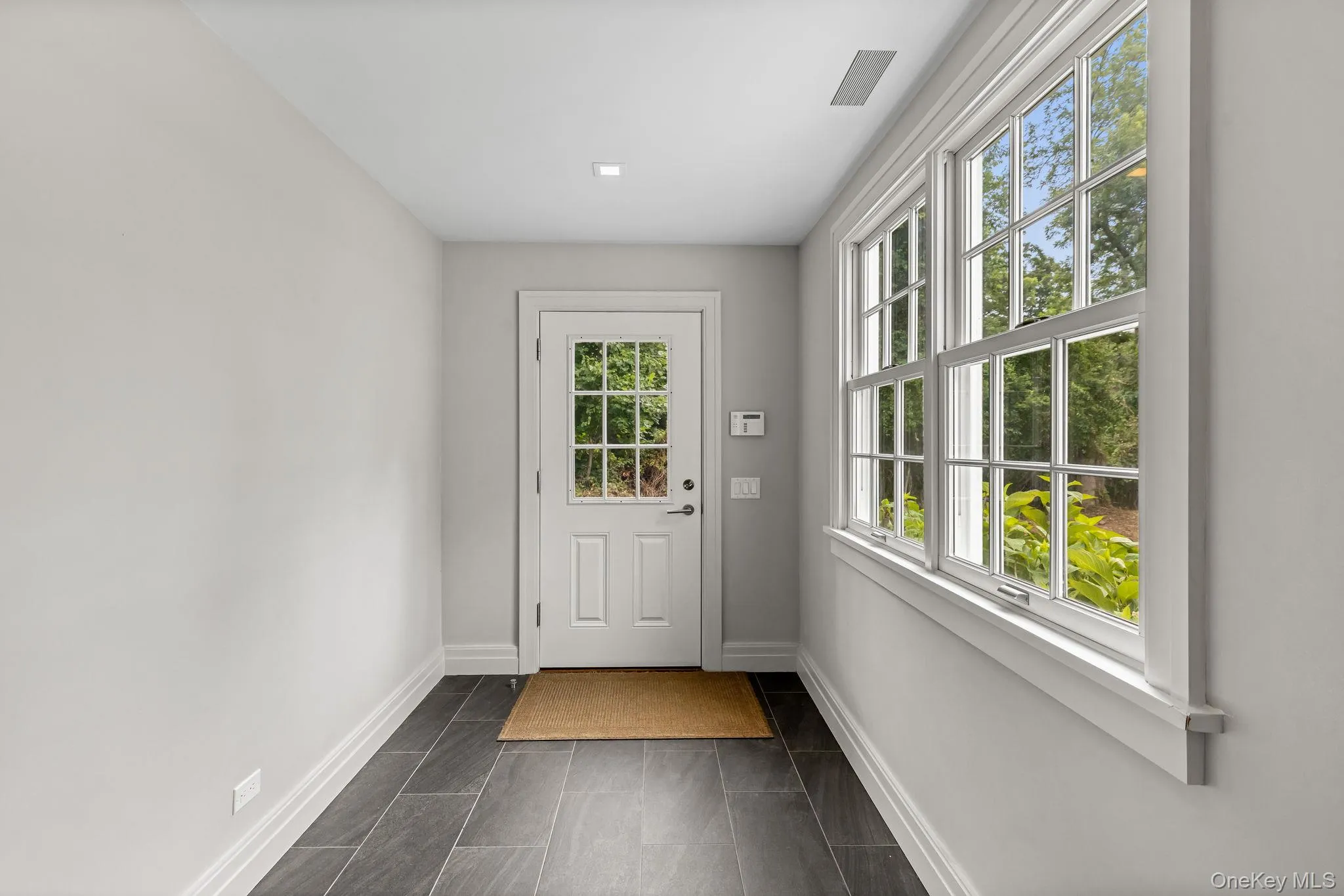 East tiled-floor entryway from driveway East tiled-floor entryway from driveway