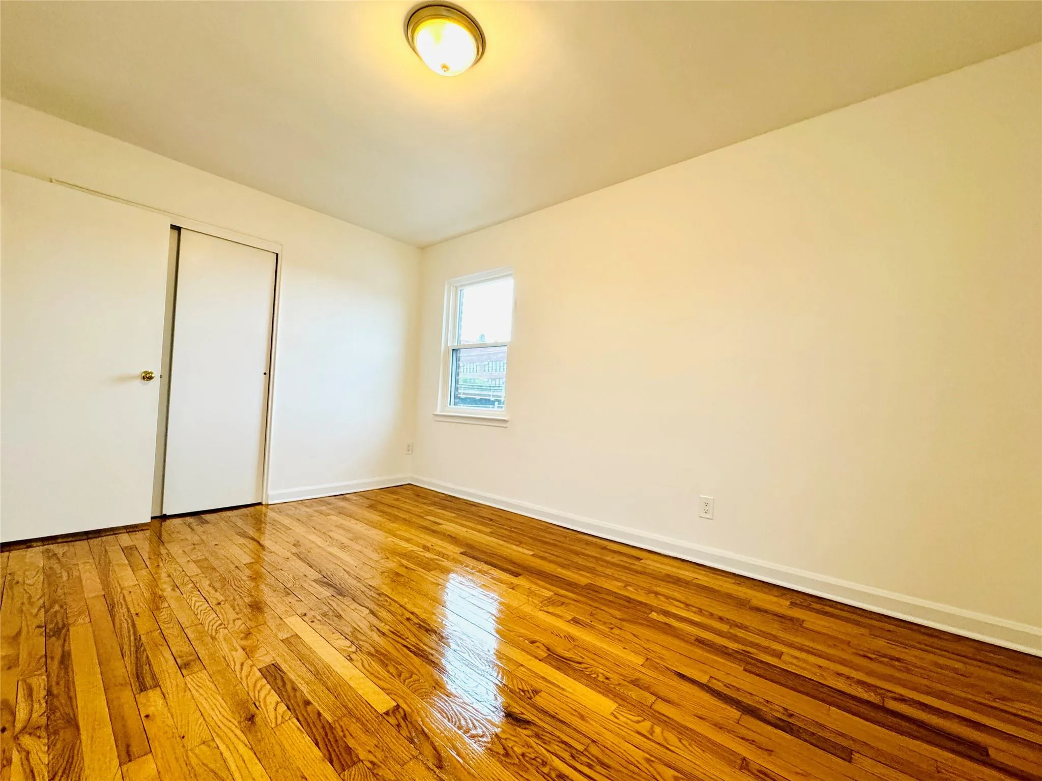 Unfurnished bedroom with light wood finished floors and a closet Unfurnished bedroom with light wood finished floors and a closet