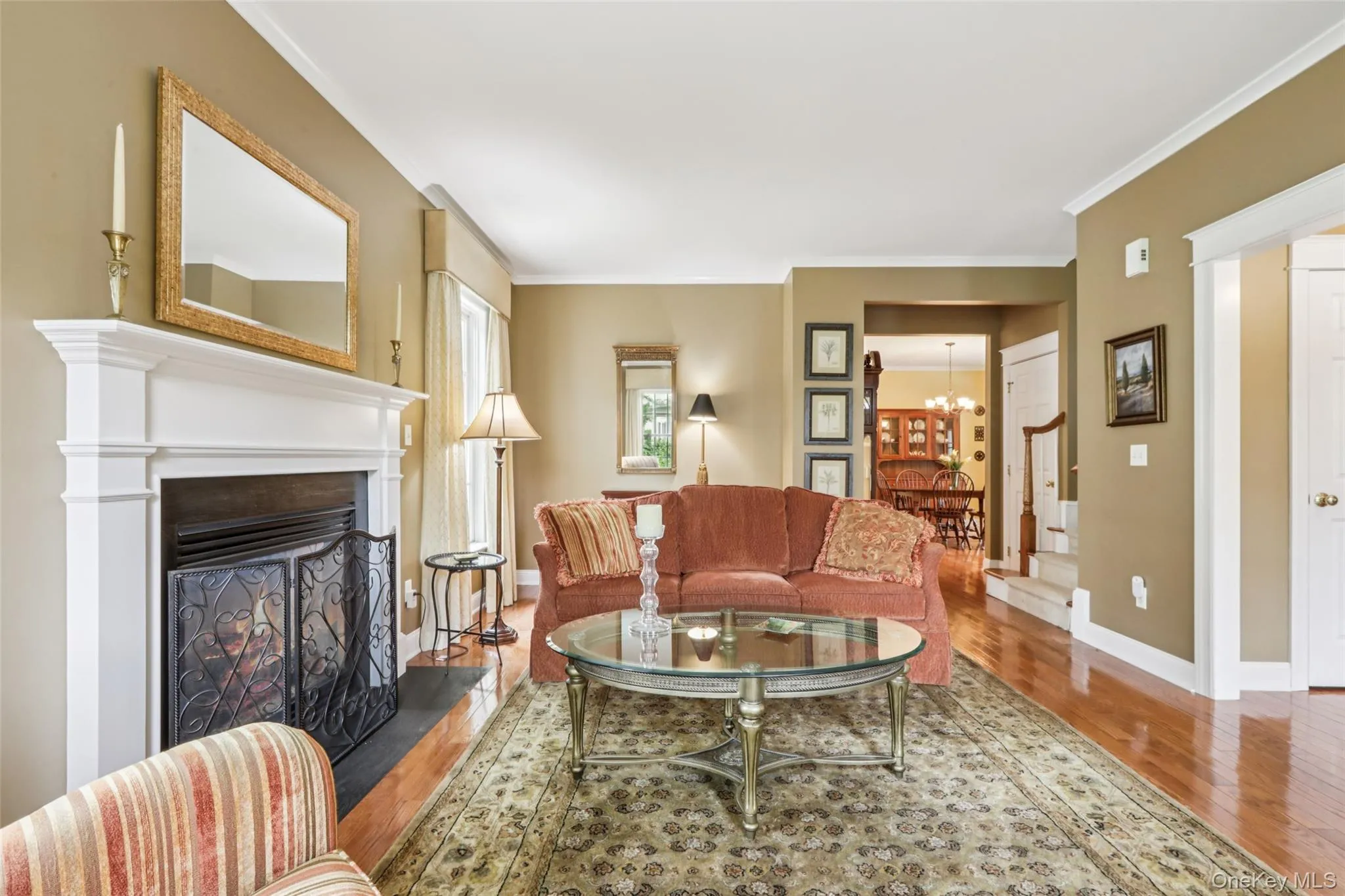 The Living Room has a gas fireplace, high ceilings, crown molding, and hardwood floors The Living Room has a gas fireplace, high ceilings, crown molding, and hardwood floors