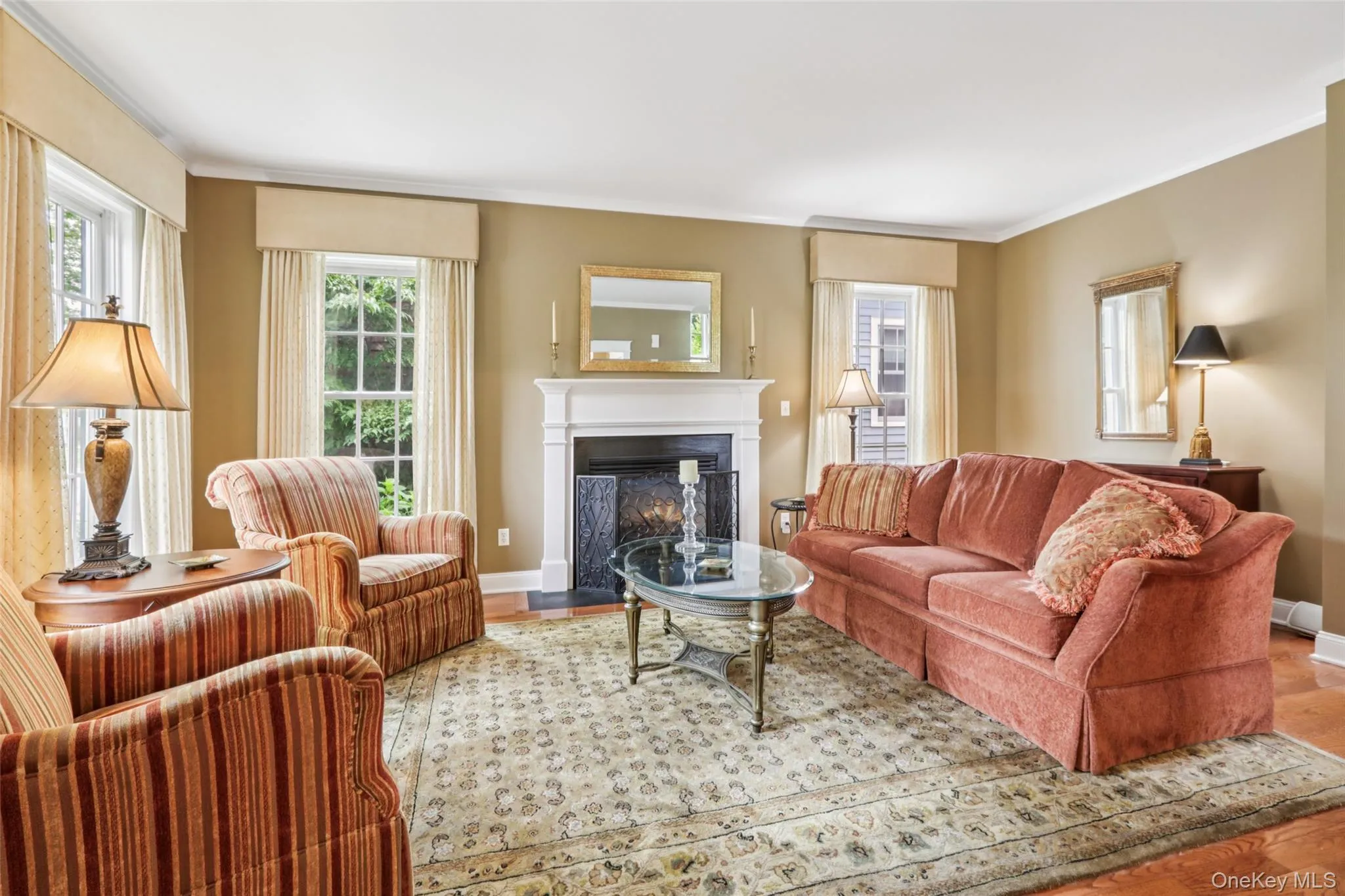 The Living Room has a gas fireplace, high ceilings, crown molding, custom window treatments, and hardwood floors The Living Room has a gas fireplace, high ceilings, crown molding, custom window treatments, and hardwood floors