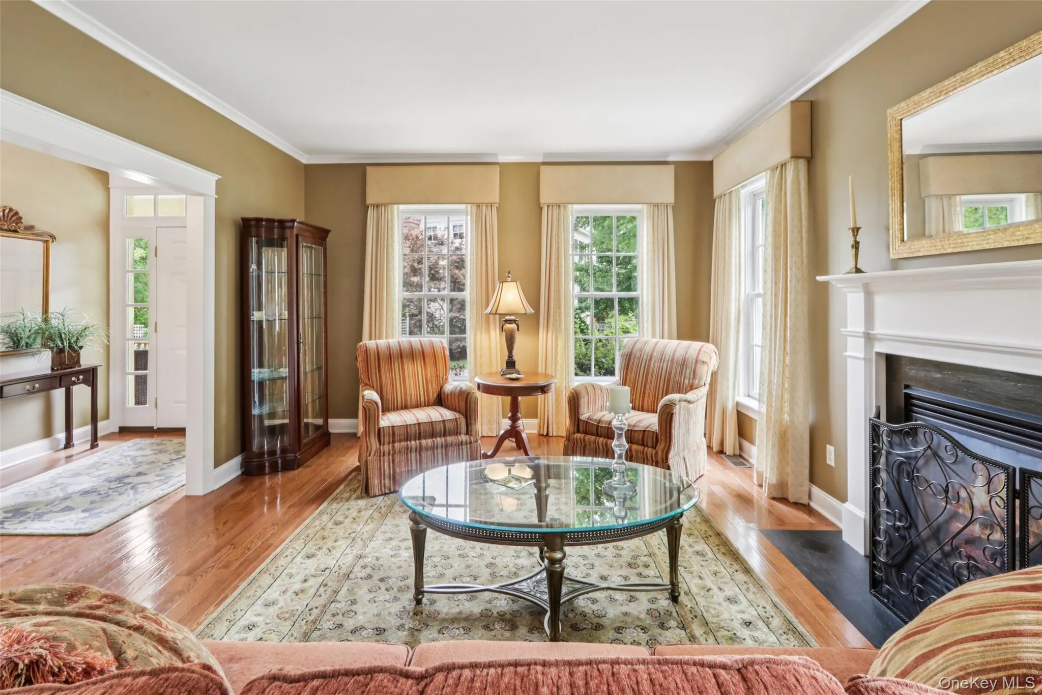 The Living Room has a gas fireplace, high ceilings, crown molding, custom window treatments, and hardwood floors The Living Room has a gas fireplace, high ceilings, crown molding, custom window treatments, and hardwood floors