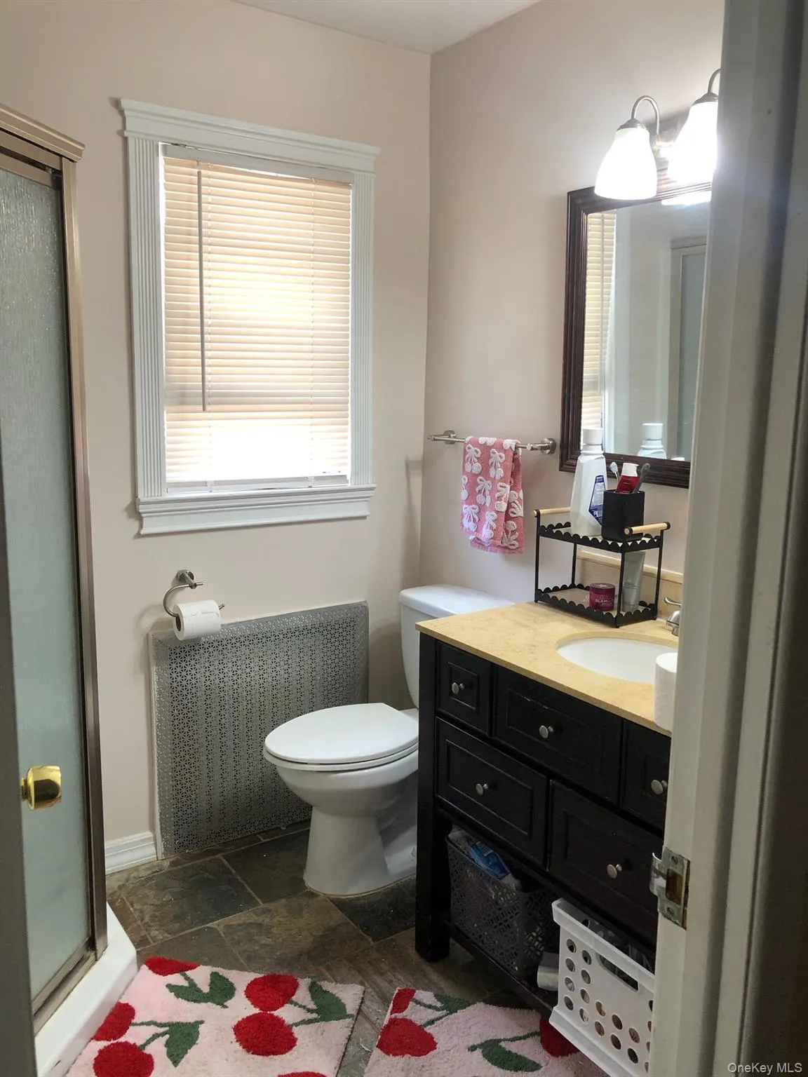 Full bathroom featuring vanity, a shower stall, and stone tile flooring Full bathroom featuring vanity, a shower stall, and stone tile flooring