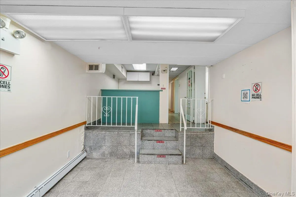 Staircase with a baseboard heating unit and granite floors Staircase with a baseboard heating unit and granite floors