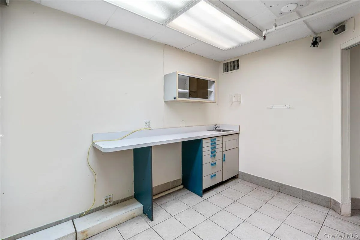 Kitchen featuring light countertops and light tile patterned floors Kitchen featuring light countertops and light tile patterned floors