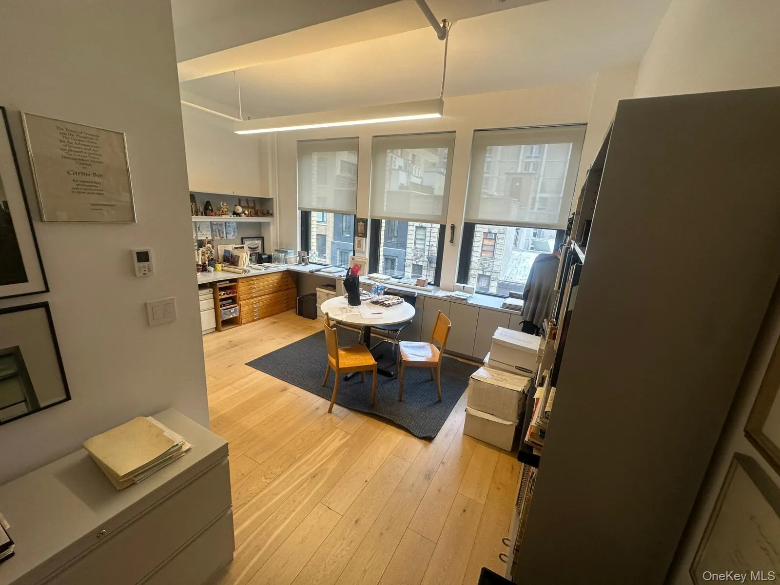 Kitchen featuring freestanding refrigerator, light wood-style floors, light countertops, and modern cabinets Kitchen featuring freestanding refrigerator, light wood-style floors, light countertops, and modern cabinets