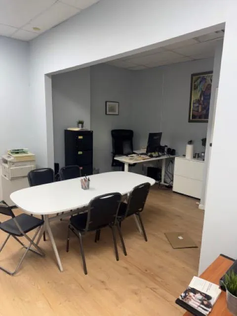 Dining room with a drop ceiling, a desk, and light wood-type flooring Dining room with a drop ceiling, a desk, and light wood-type flooring