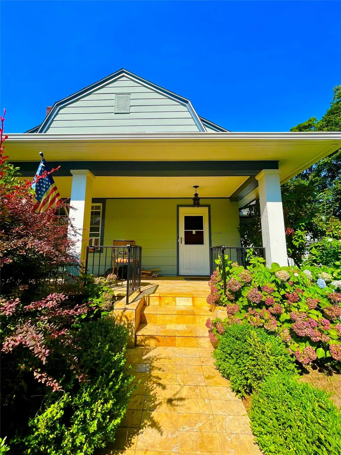 View of front of house with covered porch and a gambrel roof View of front of house with covered porch and a gambrel roof