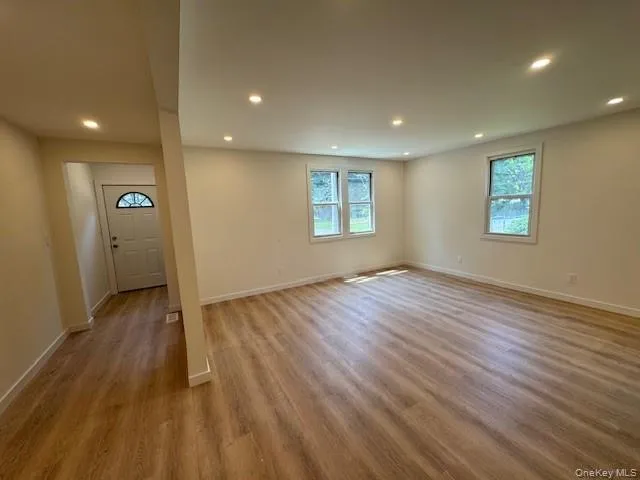 Entrance foyer with plenty of natural light, wood finished floors, and recessed lighting Entrance foyer with plenty of natural light, wood finished floors, and recessed lighting
