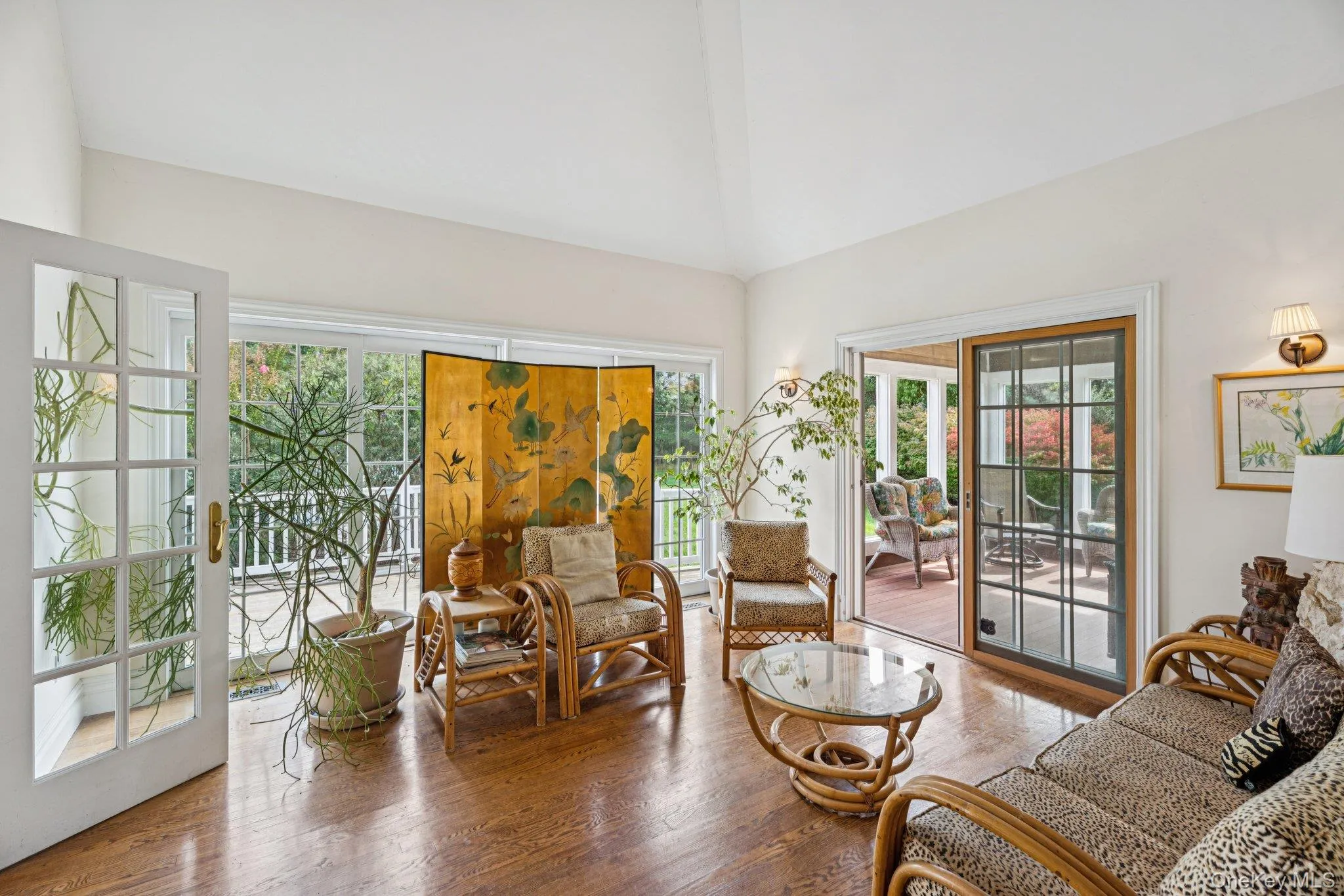 An inviting living area adorned with rich wood-finished floors and a breathtaking cathedral ceiling that enhances the home’s airy elegance. An inviting living area adorned with rich wood-finished floors and a breathtaking cathedral ceiling that enhances the home’s airy elegance.